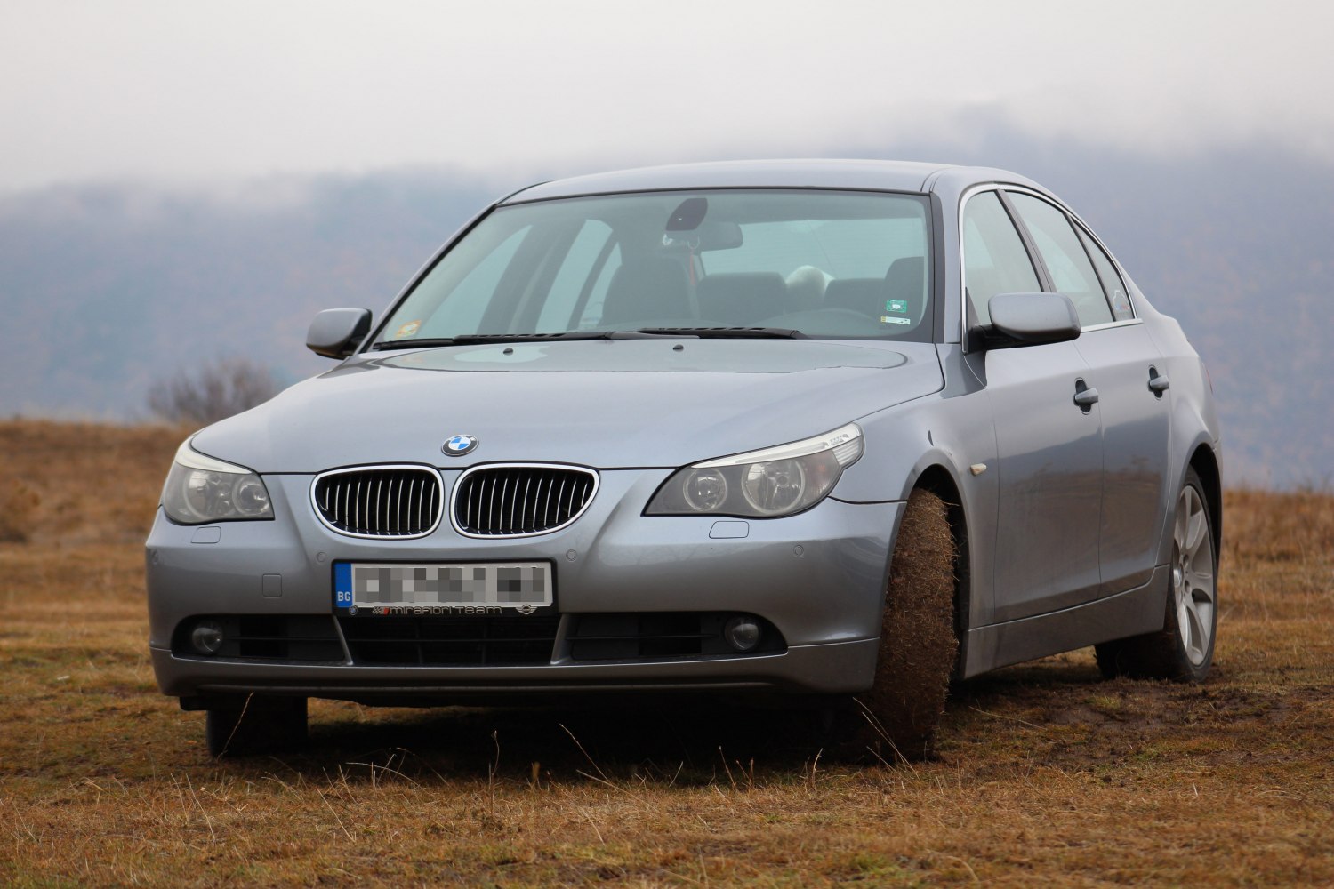 Front view with kidney grille and headlights on silver sedan