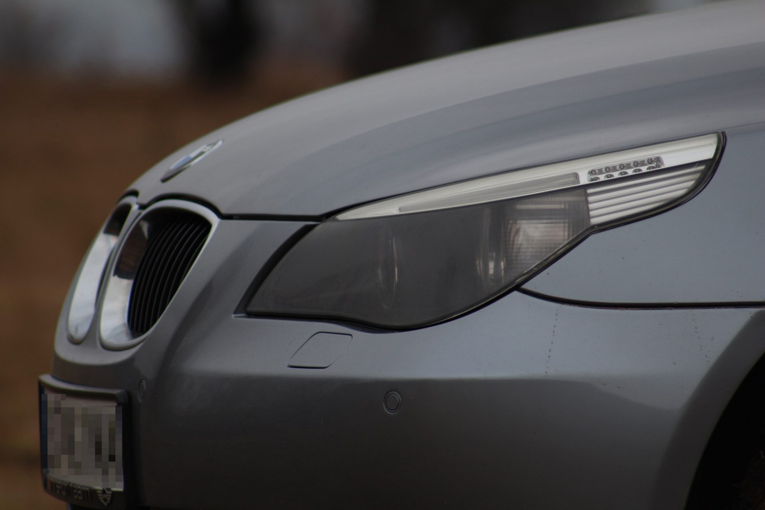 Close-up of front headlight and kidney grille