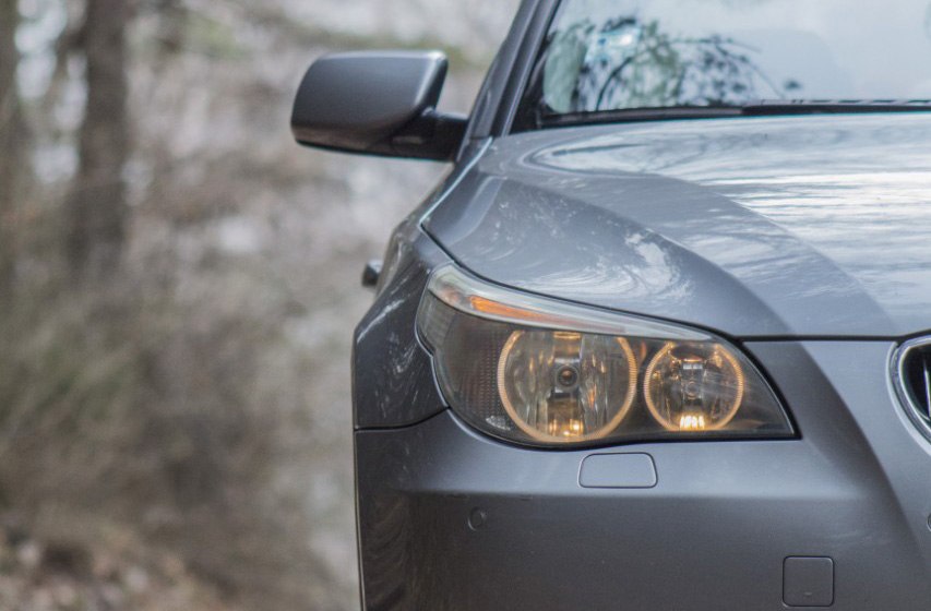 Close-up of BMW E60 headlight and front side mirror