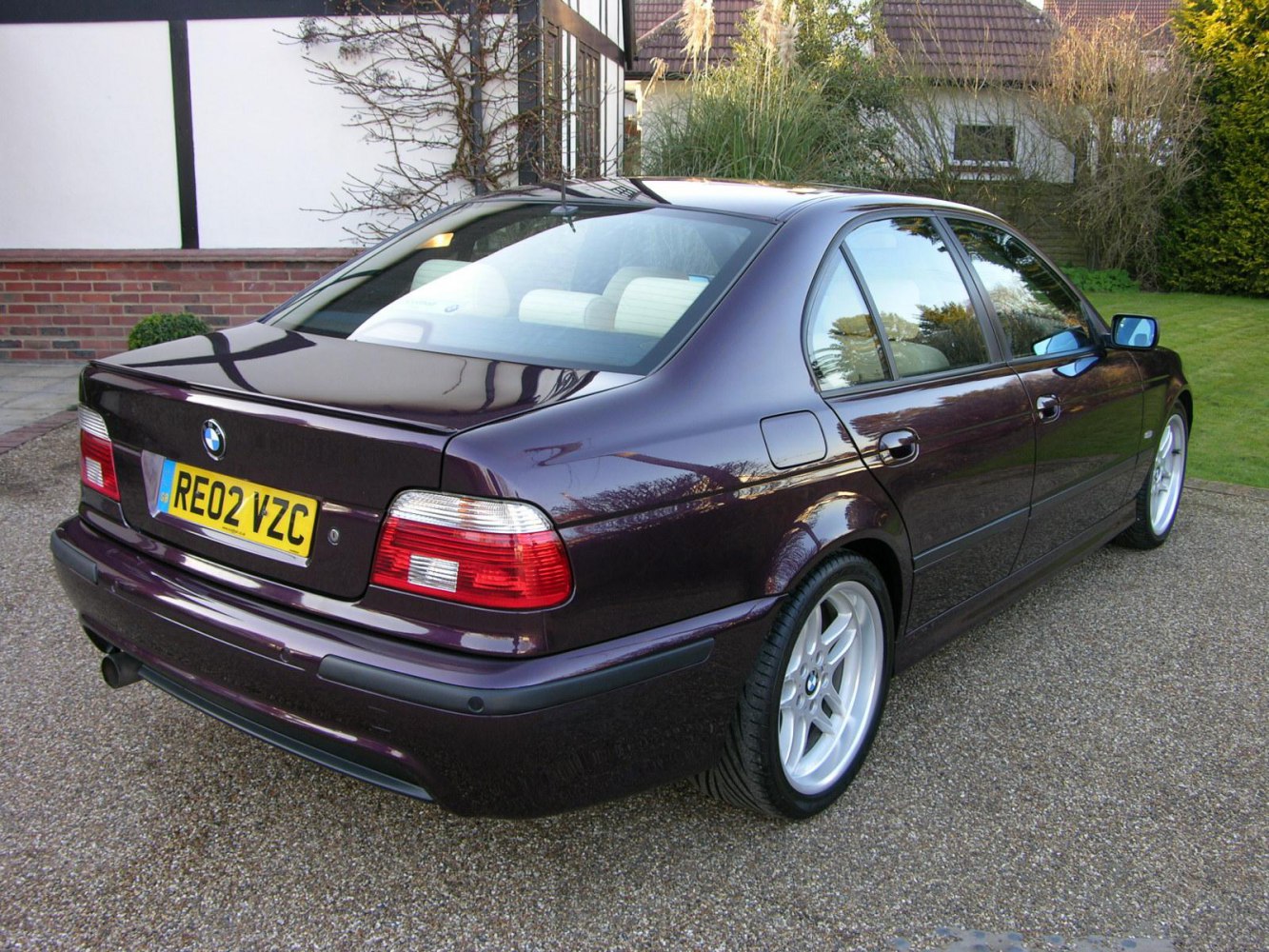 Rear and side view of a 1999-2004 luxury sedan with distinct tail lights and alloy wheels