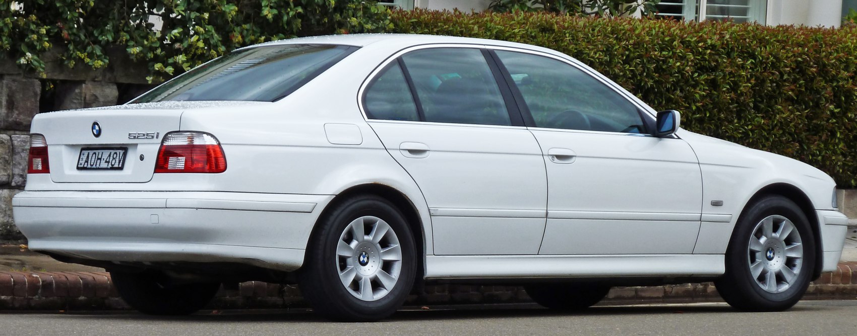 Rear and side profile of a sedan with alloy wheels and distinct rear lights