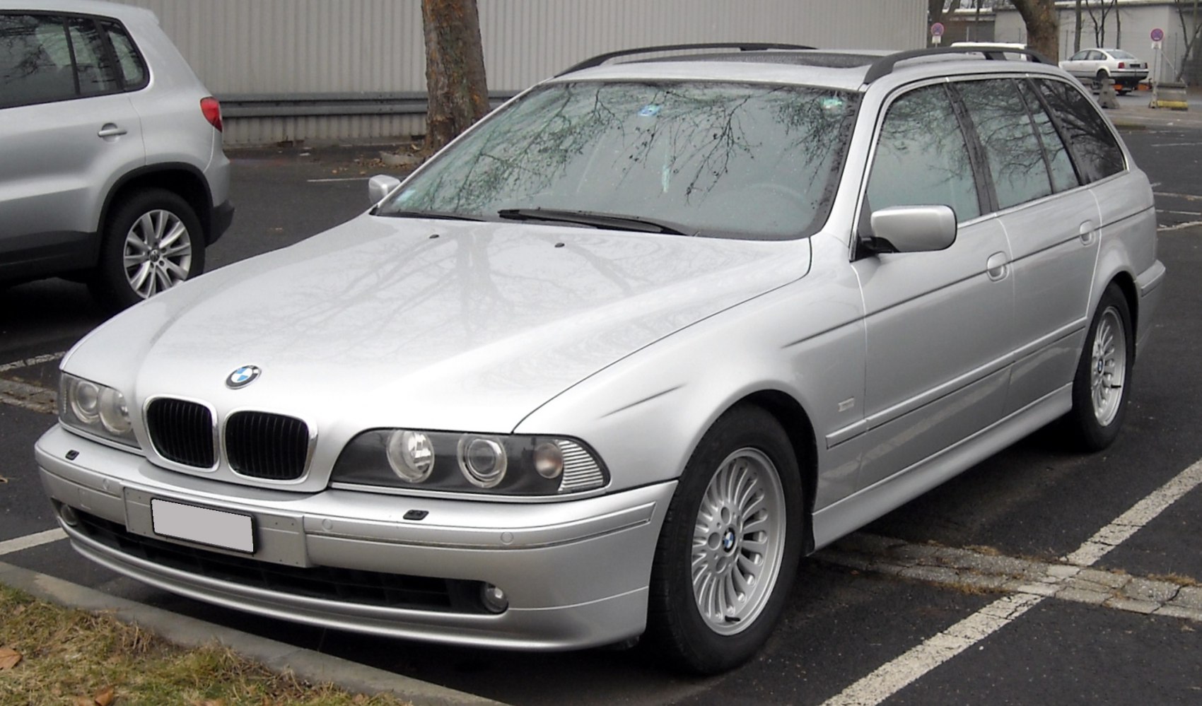 Silver station wagon with dual round headlights and kidney grille
