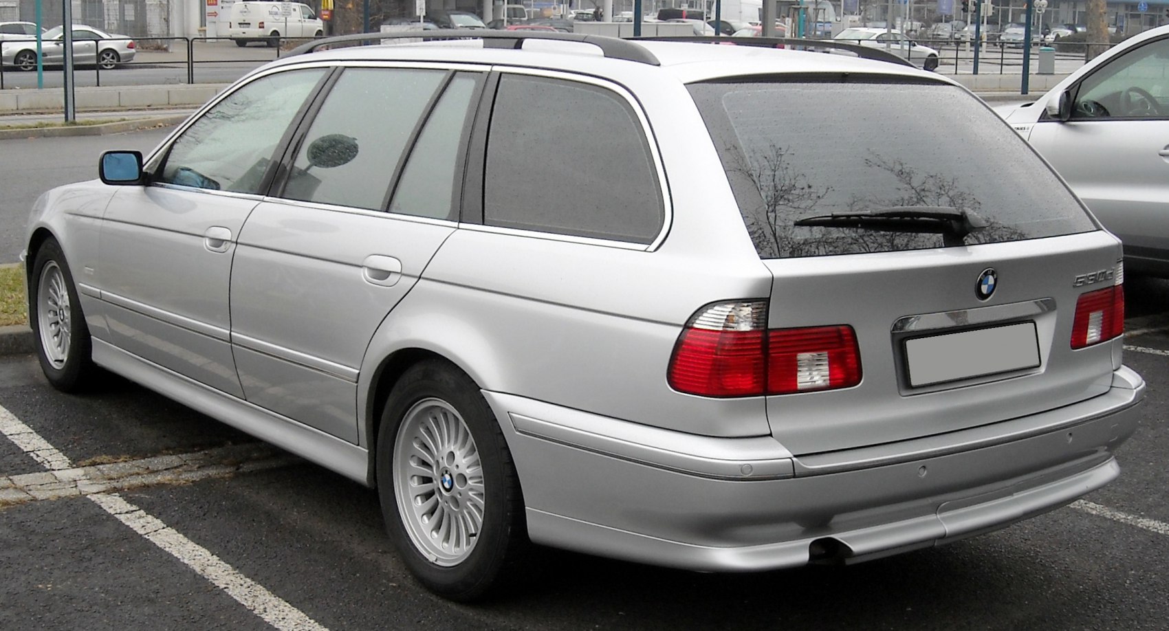 Rear-side view of estate car with distinct tail lights and alloy wheels