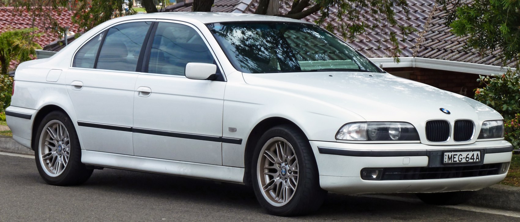 White sedan with dual kidney grille and alloy wheels