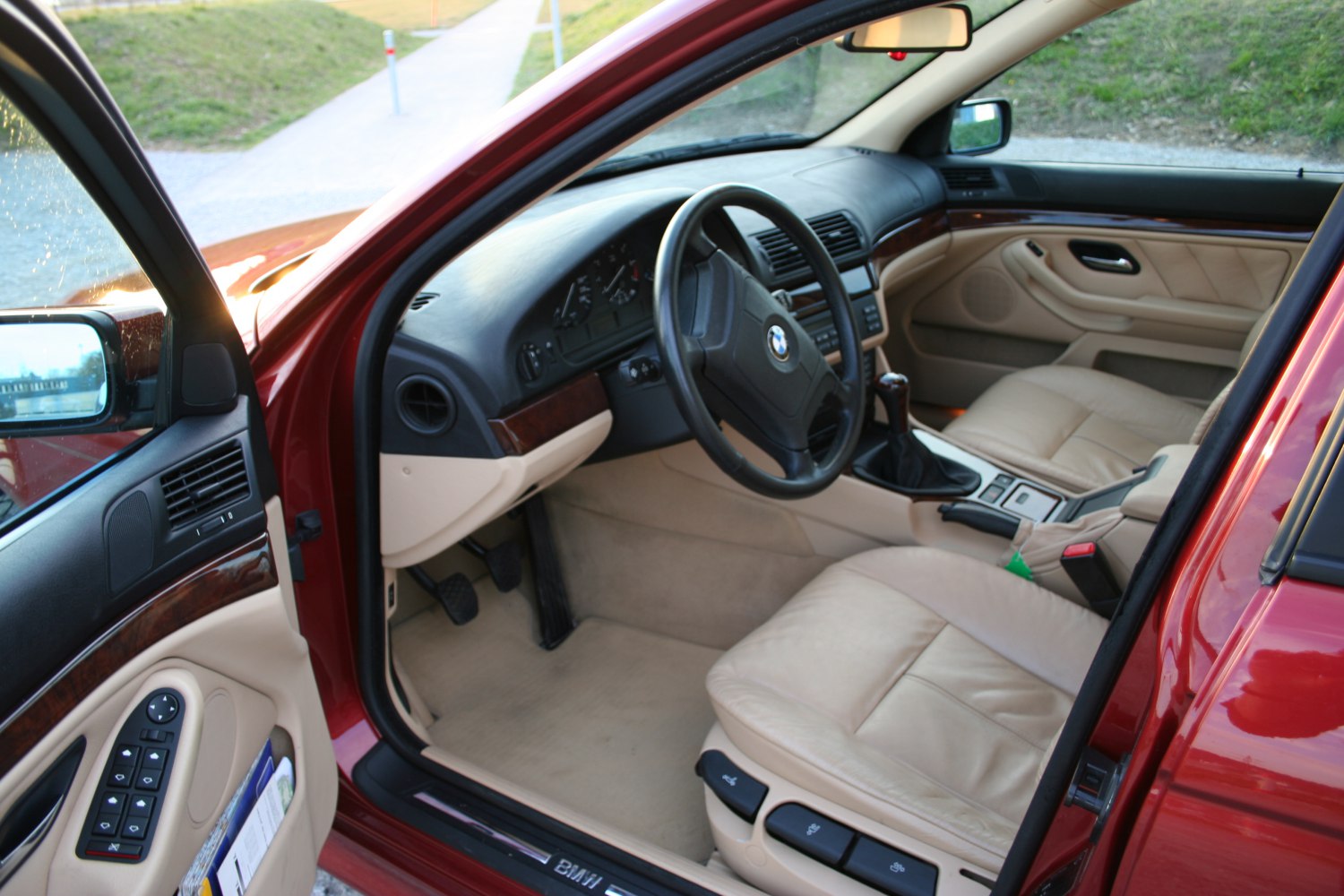Beige leather interior with wood trim and manual gear stick