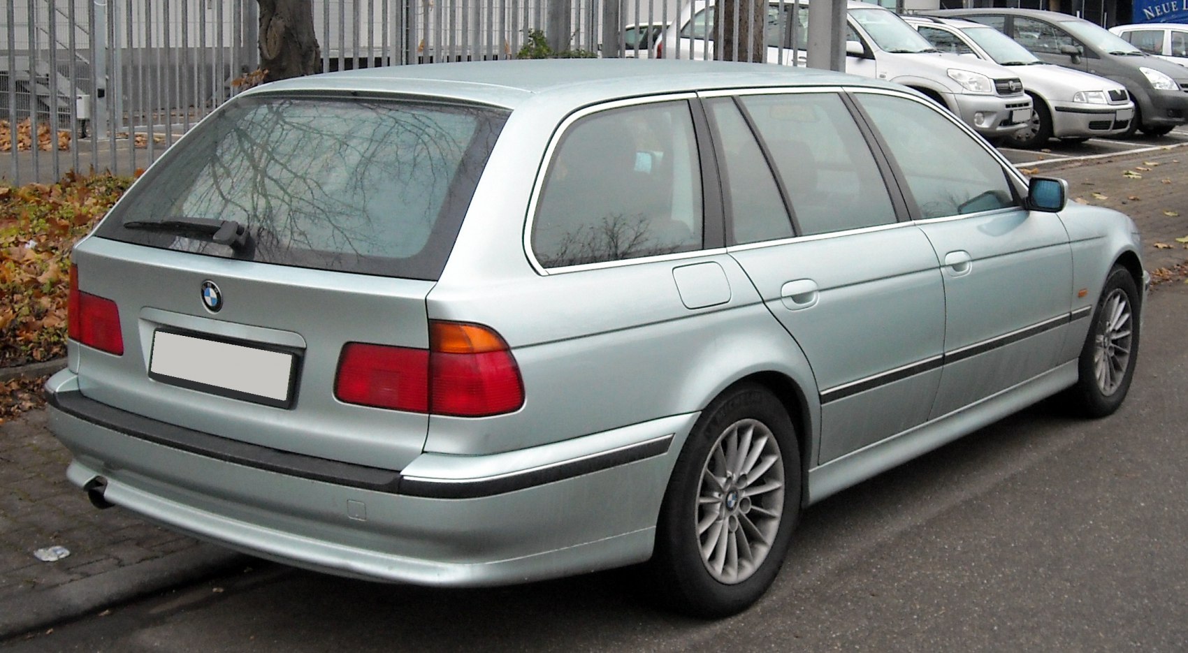 Rear-side view of classic station wagon with alloy wheels and rear hatchback