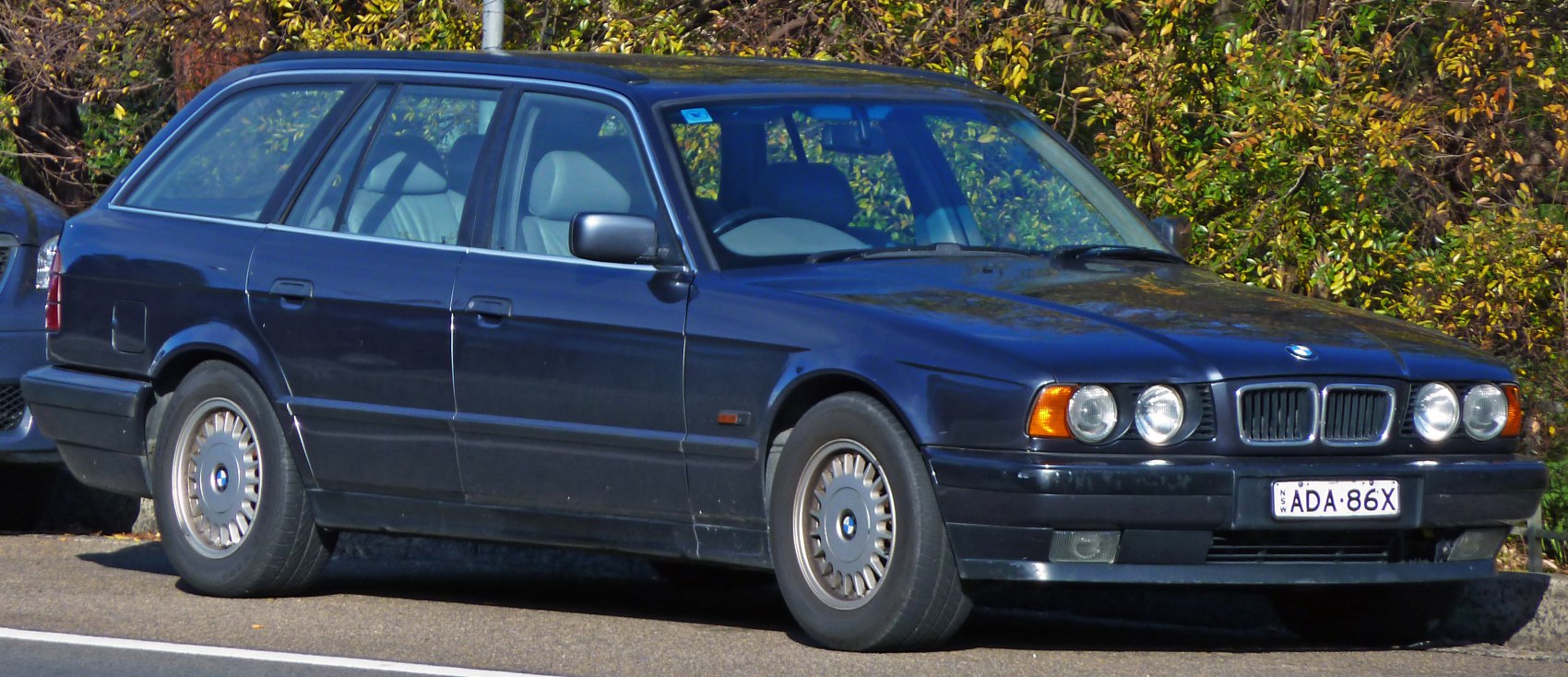 1990s station wagon with quad round headlights and extended rear design