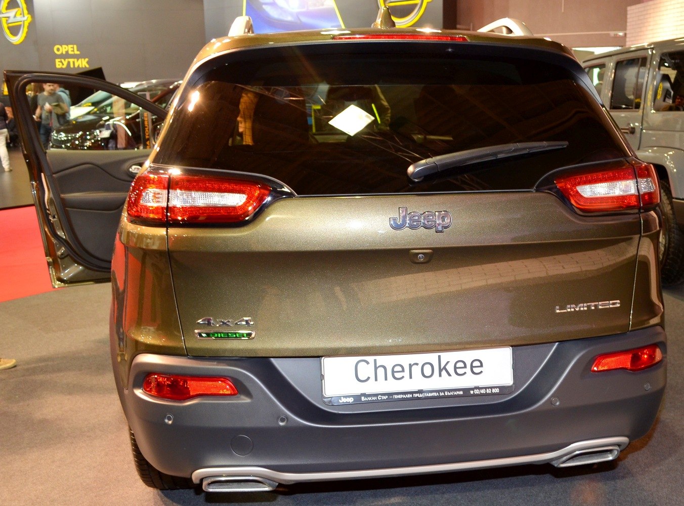Rear view with taillights, 4x4 diesel badge, dual exhaust outlets