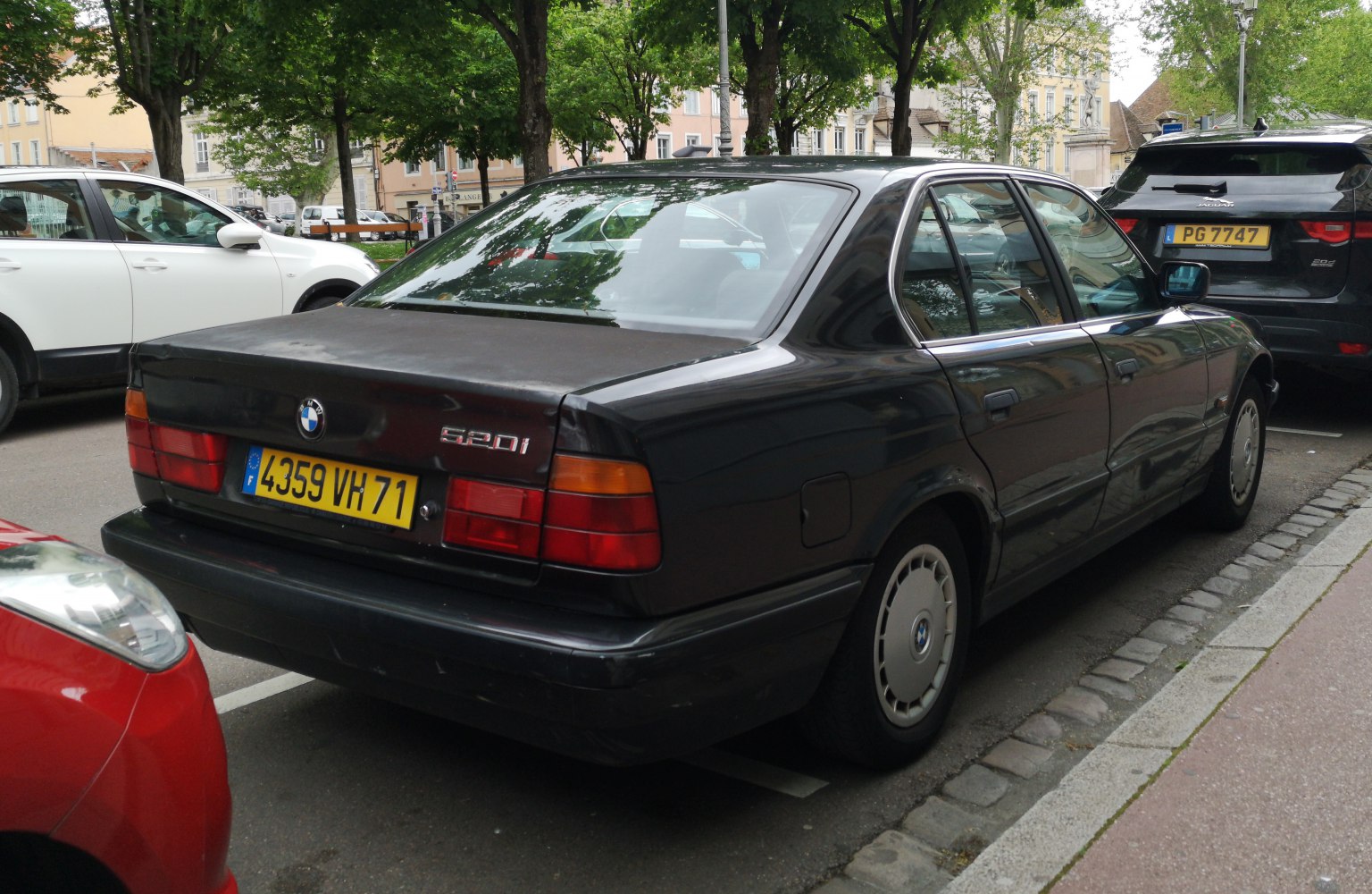 Rear side view of a 1980s sedan with taillights and distinct body lines