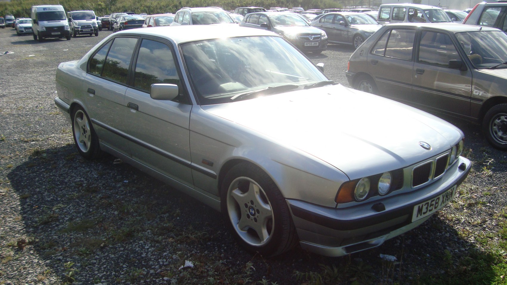 Silver sedan with alloy wheels and dual circular headlights