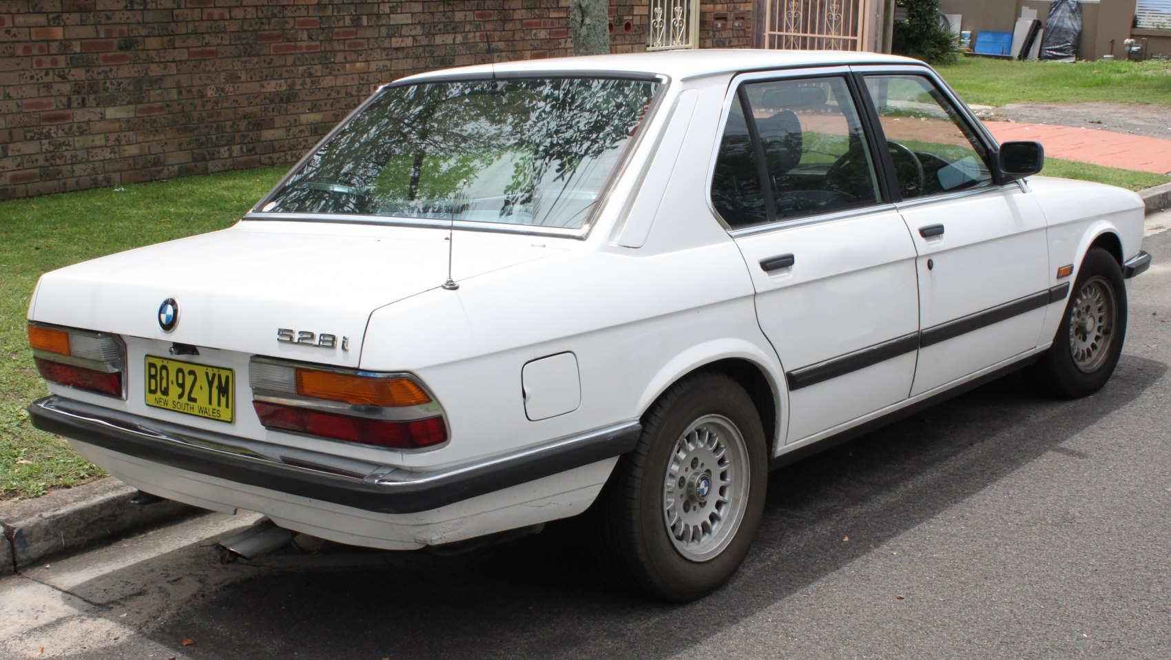 Rear side profile of vintage sedan featuring classic design elements.