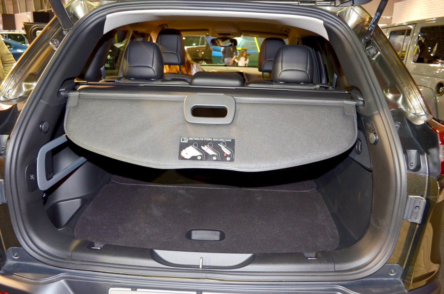 Retractable cargo cover and spacious rear storage compartment