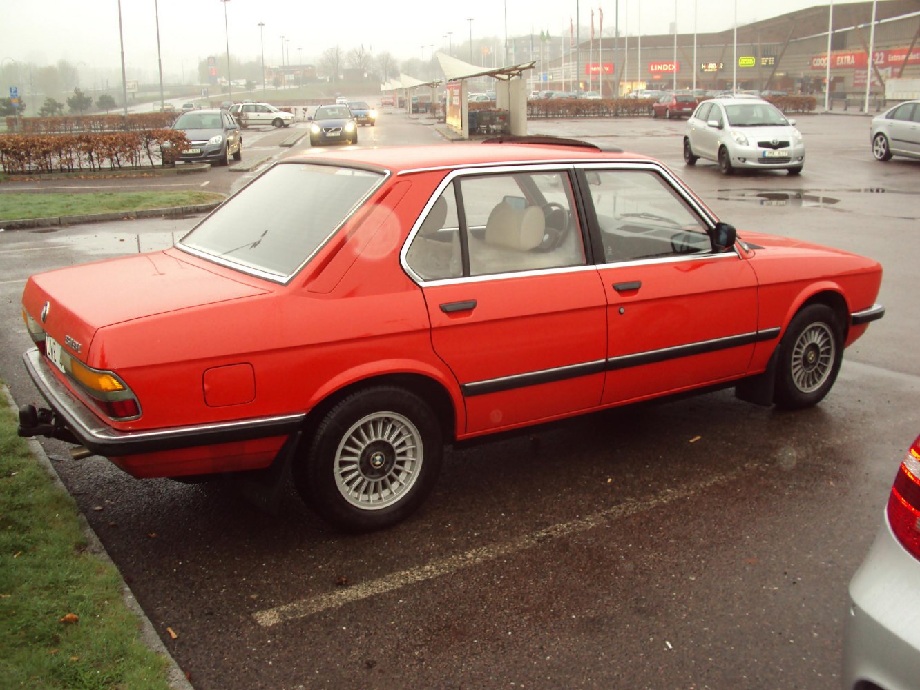 Red vintage sedan with alloy wheels and rear tow hitch