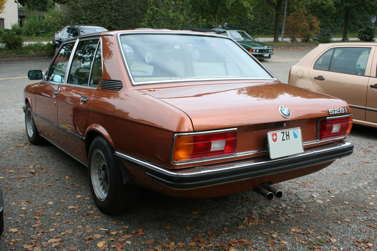 Rear view showing tail lights, chrome bumper, and dual exhaust pipes on vintage sedan