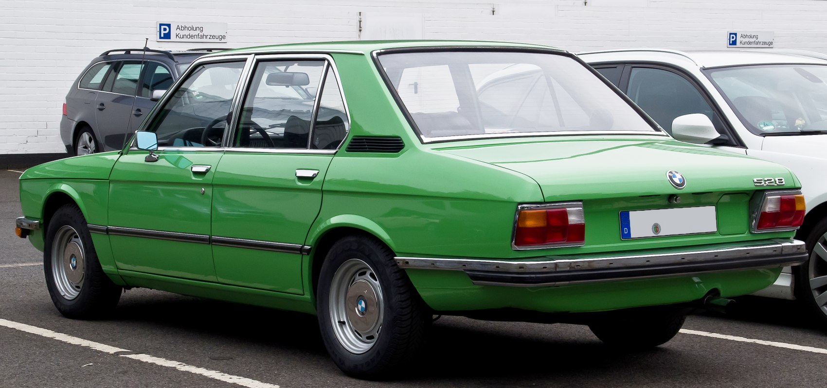 Vintage 1970s sedan rear and side profile with rectangular taillights and chrome bumper