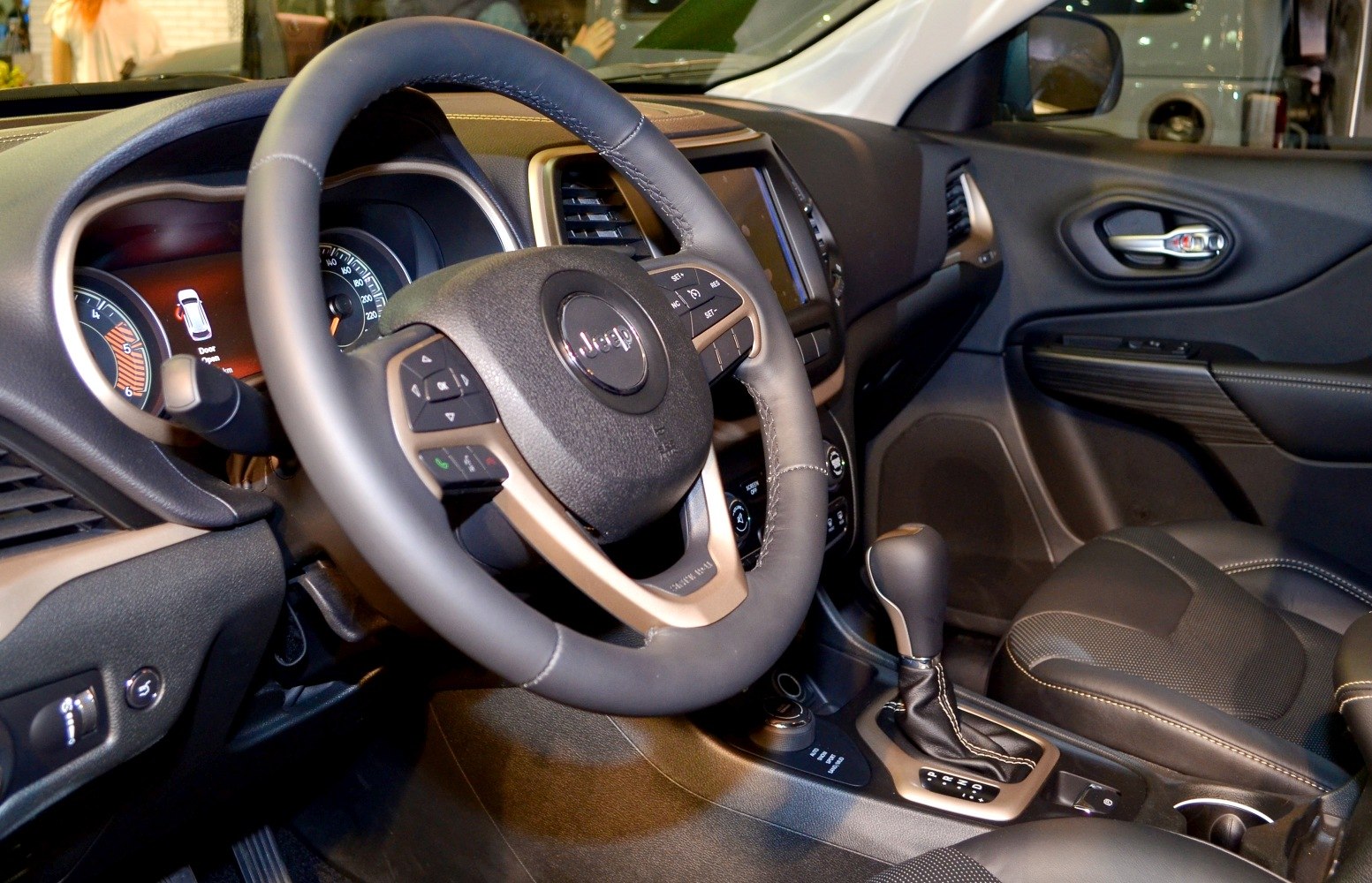Steering wheel with multi-function buttons and dashboard inside a vehicle