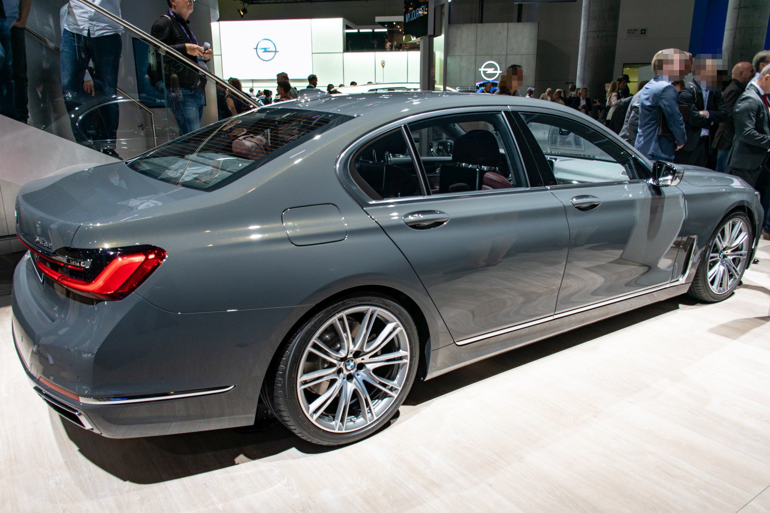 Rear and side profile of a luxury sedan with alloy wheels and distinctive LED taillights