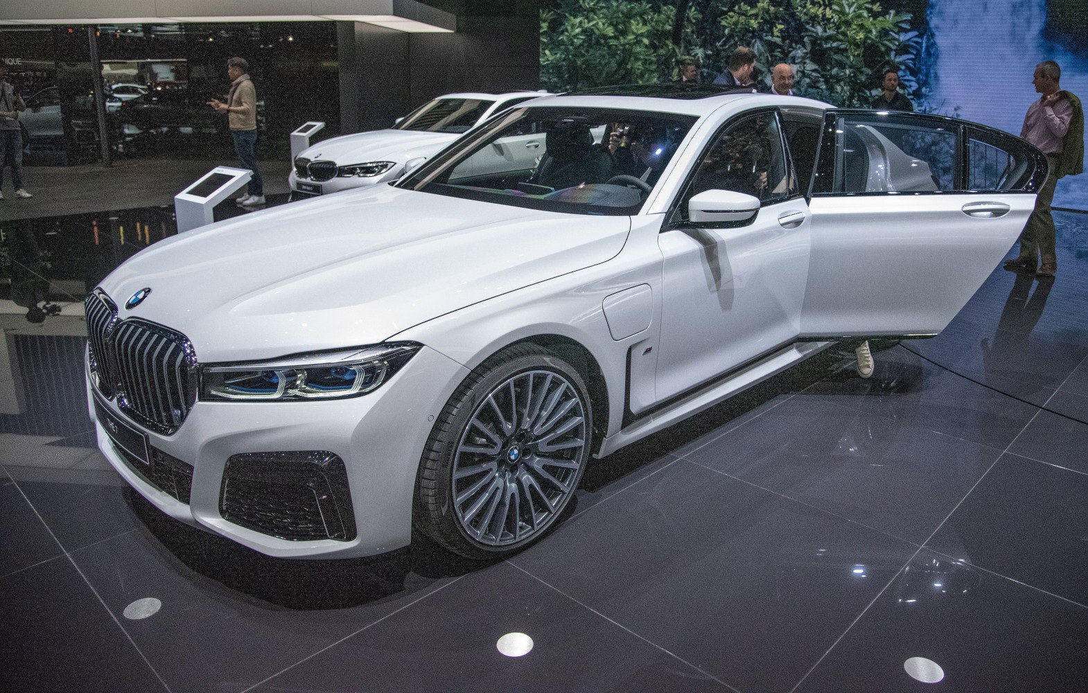 Front and side view of luxury sedan with open door, LED headlights, elegant wheels