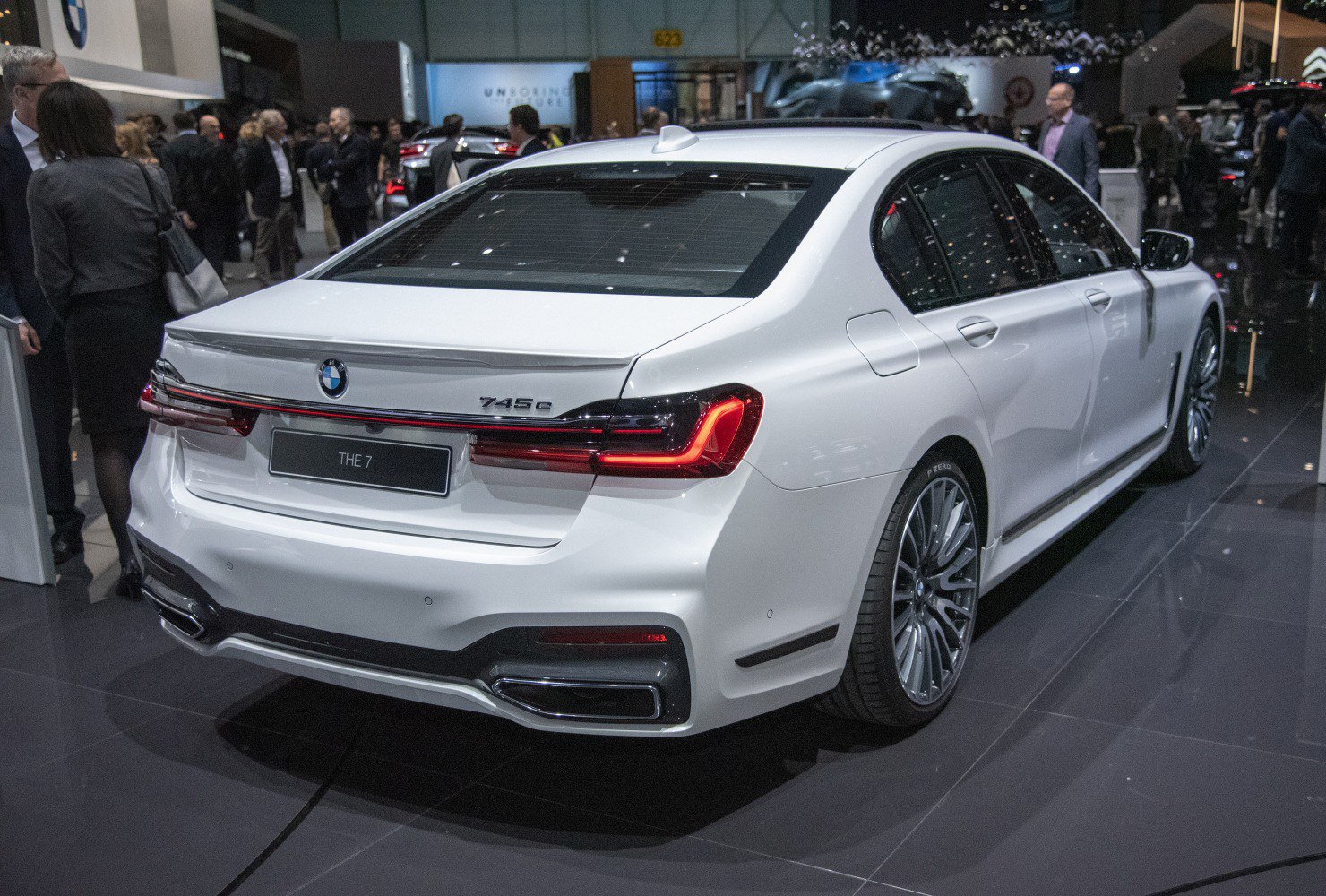 Rear view of luxury sedan with LED tail lights and dual exhausts