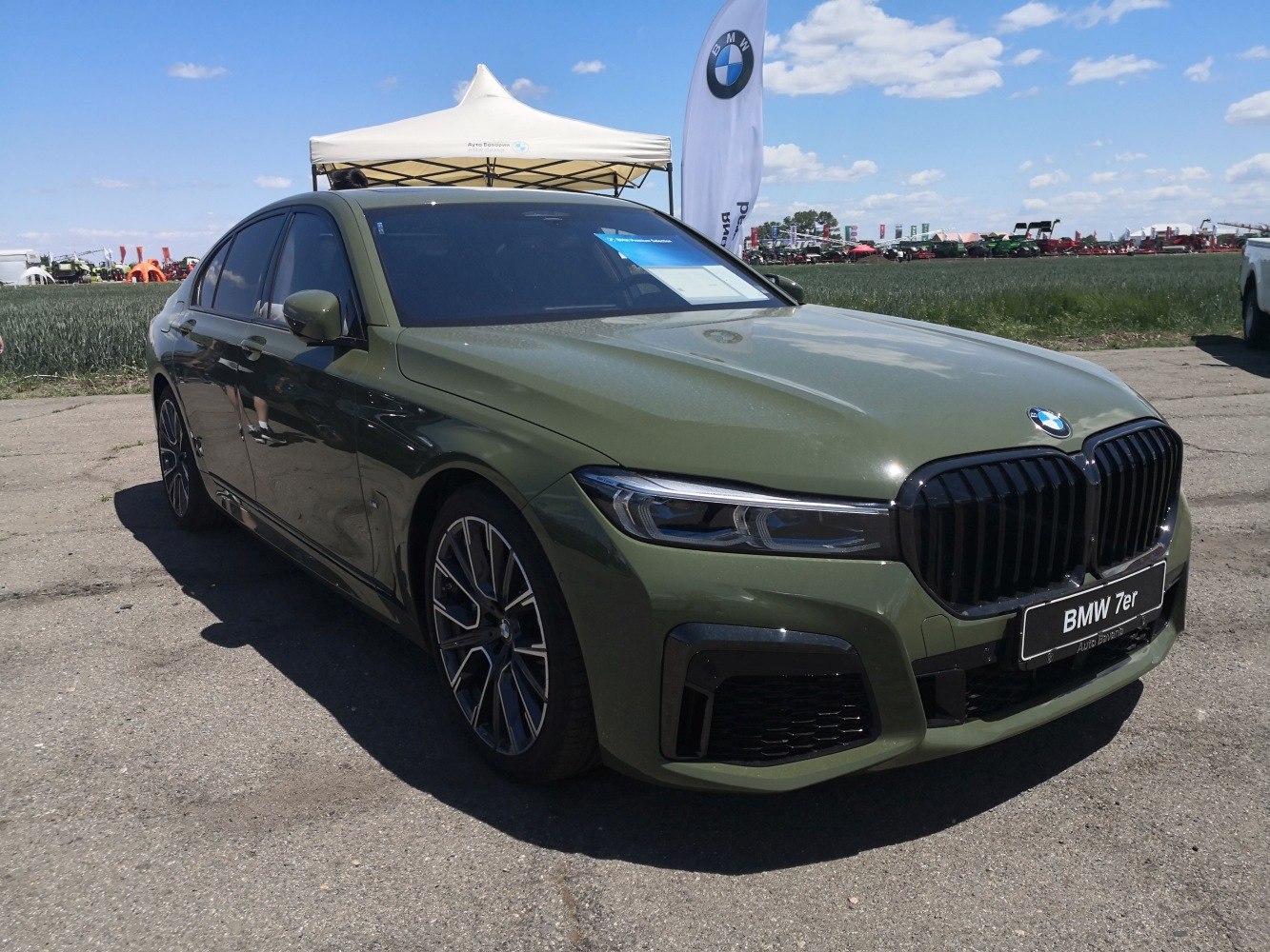 Front view green sedan with black kidney grille and LED headlights