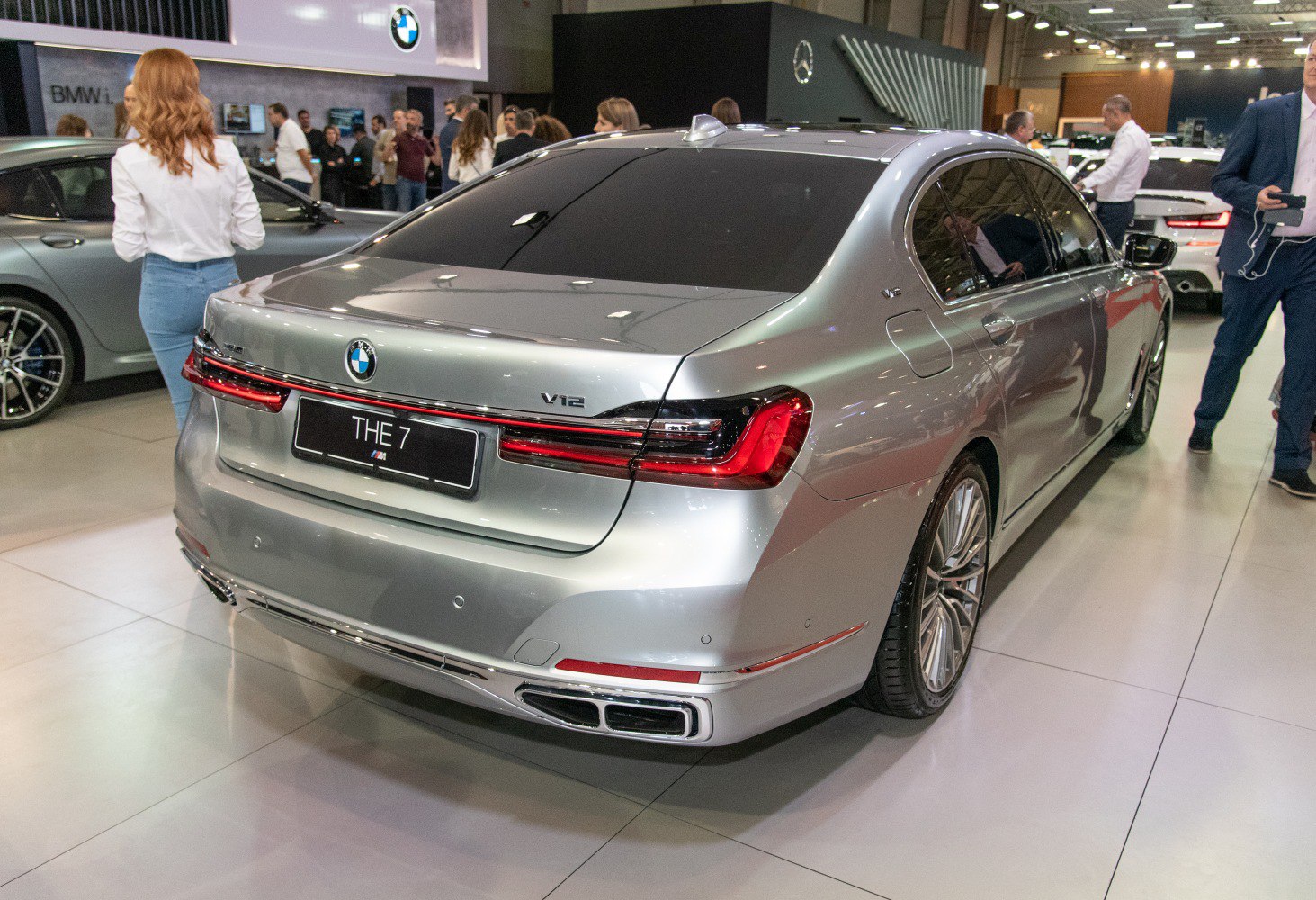 Luxury sedan rear with signature taillights and V12 badging