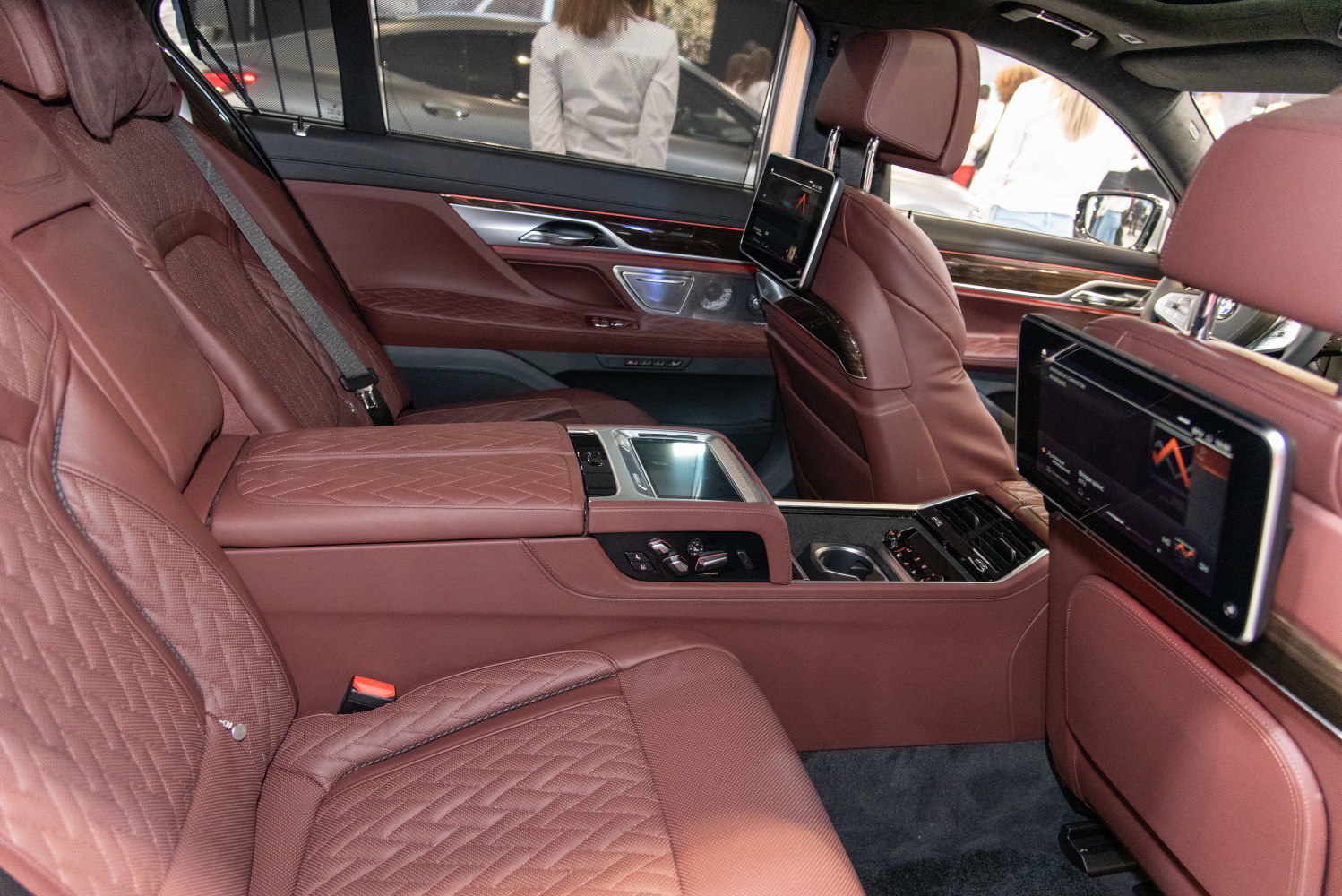 Luxury rear seats with leather, entertainment screens, and control panel