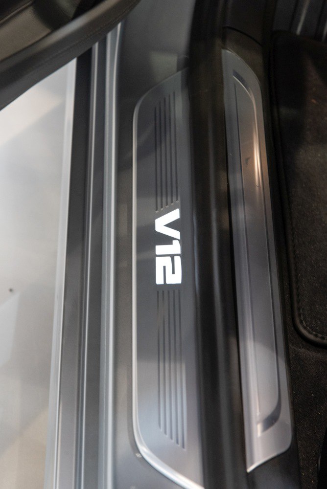 Illuminated door sill with V12 emblem