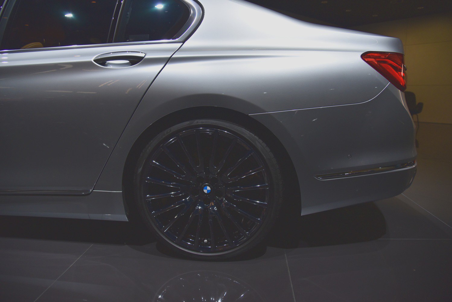 Rear side view with black multi-spoke alloy wheel and sleek body lines