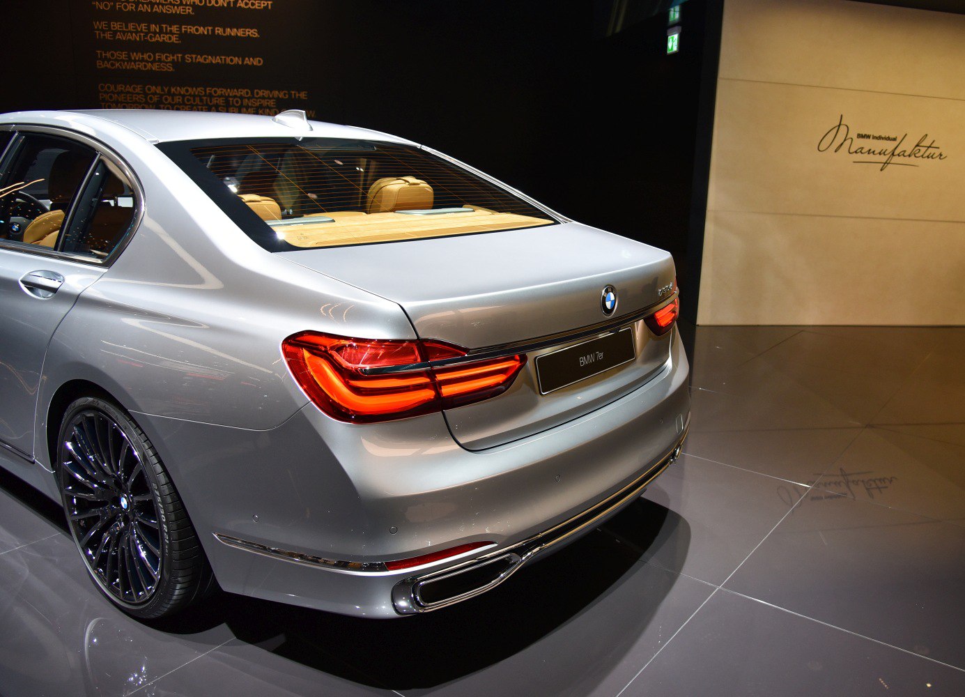 Silver sedan rear end with LED taillights and dual exhaust
