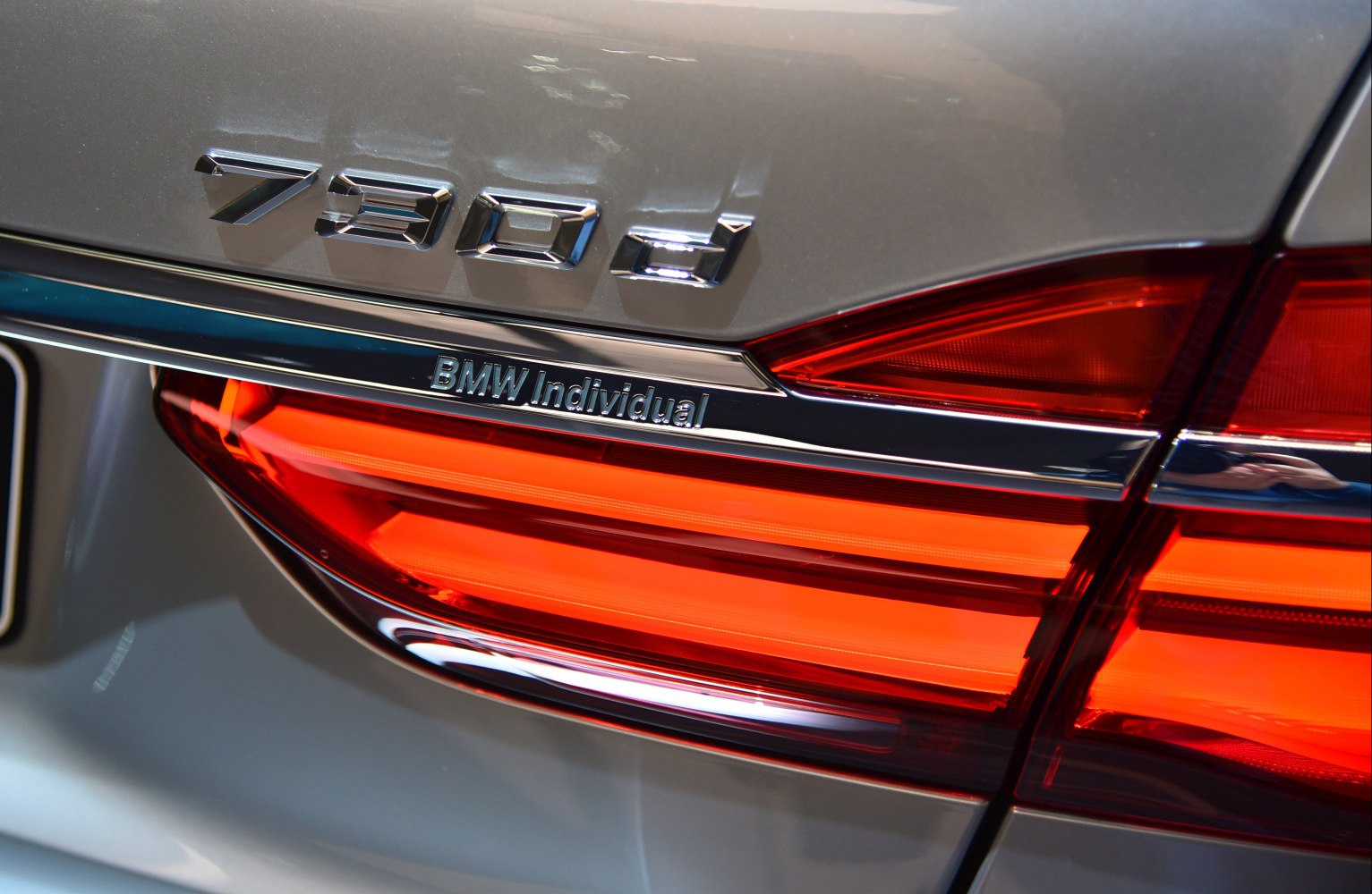 Close-up of rear badge '730d' and illuminated tail light