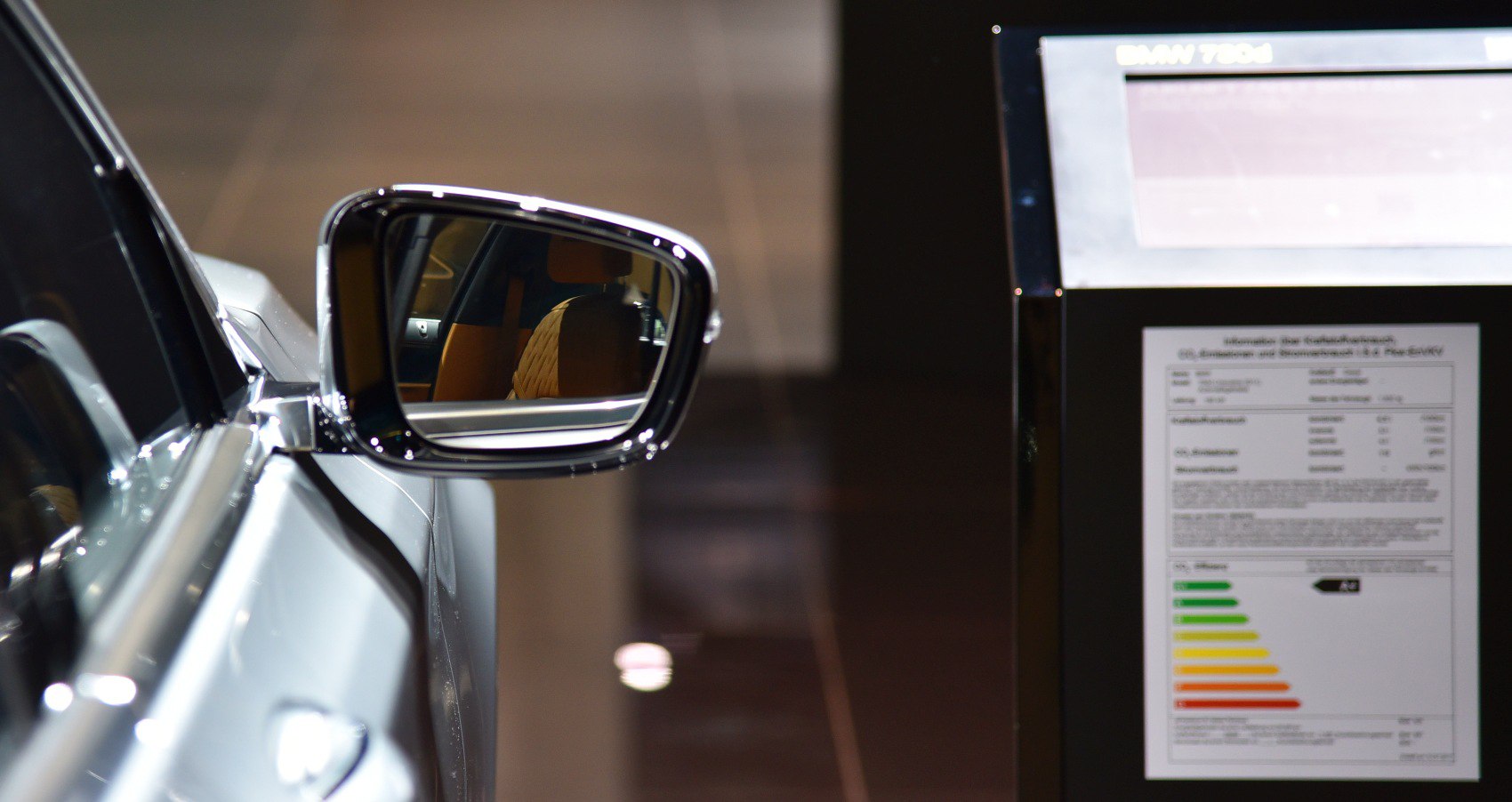 Side mirror reflecting quilted luxury seat upholstery