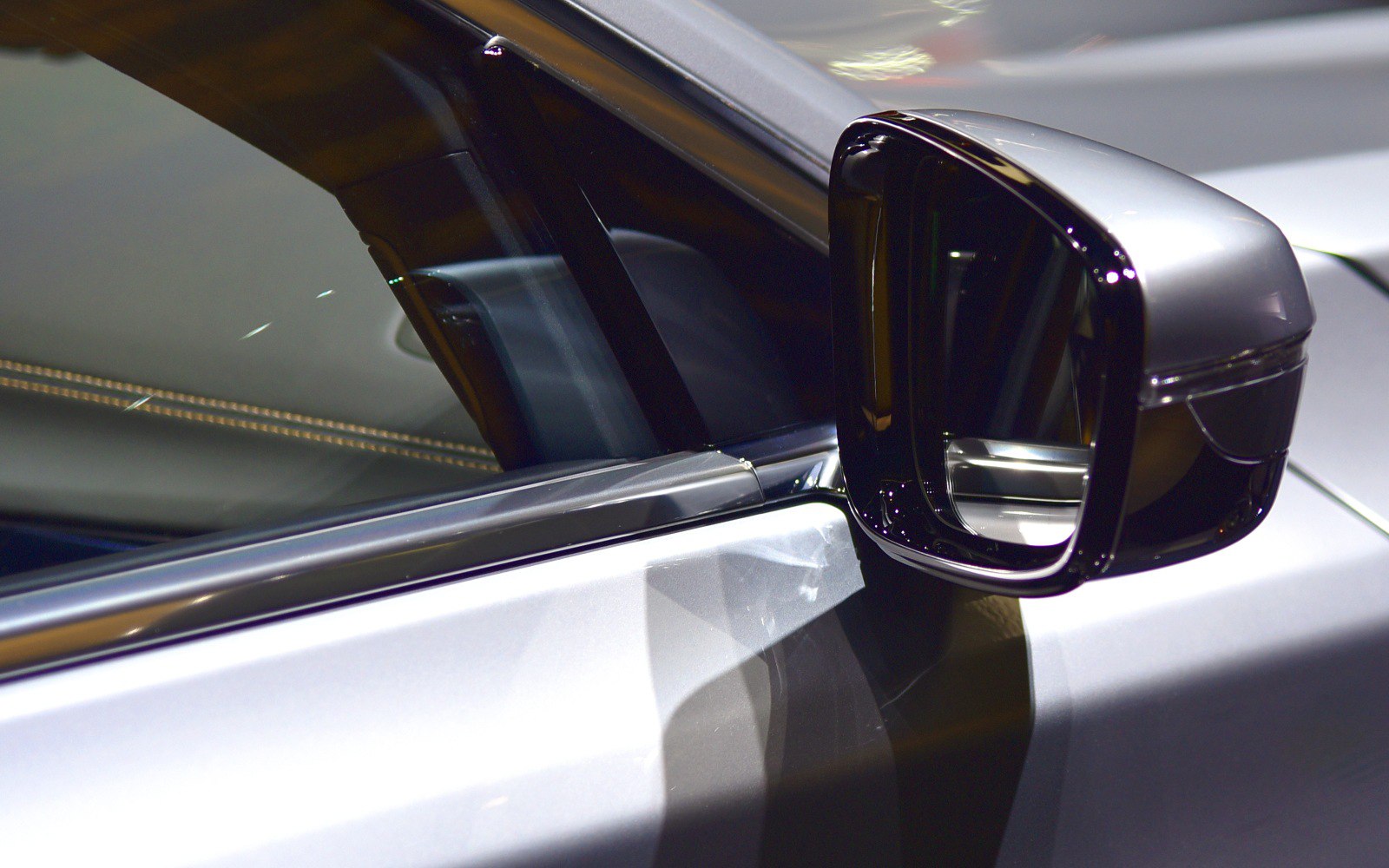 Close-up of sleek side mirror on luxury vehicle door
