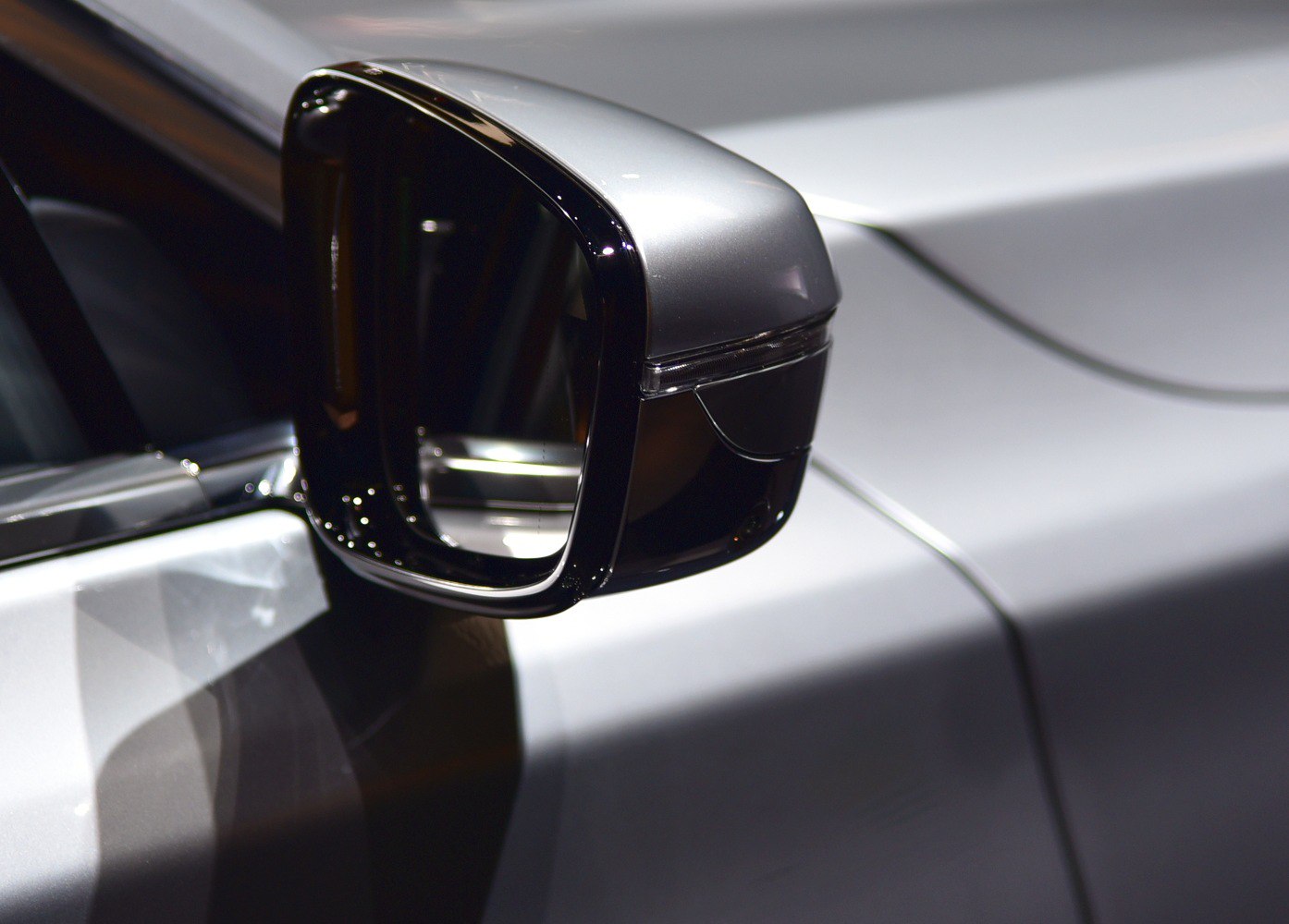 Close-up of BMW 7 Series side mirror with aerodynamic design