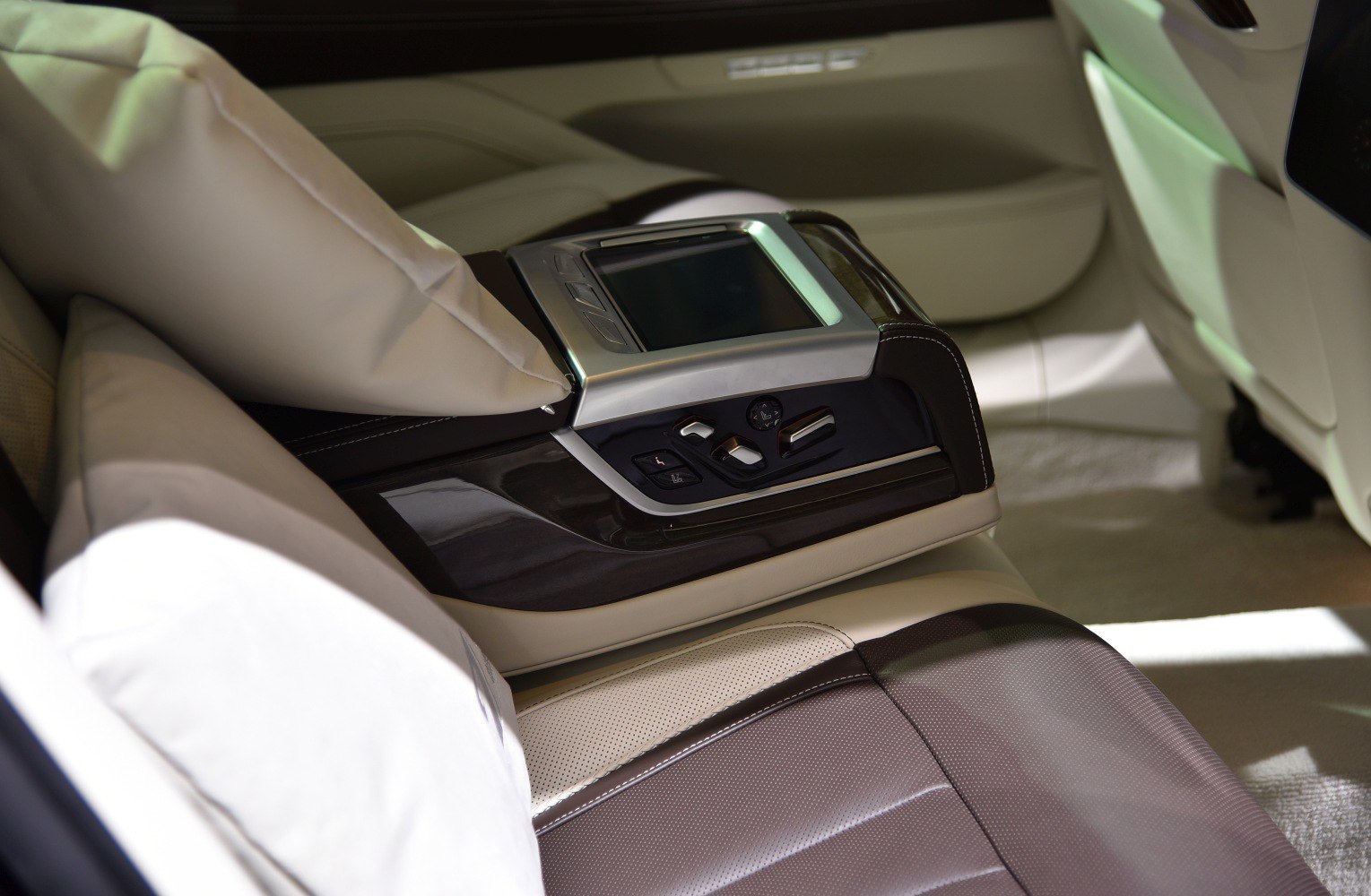 Luxury rear seat controls with touchscreen in leather-upholstered interior