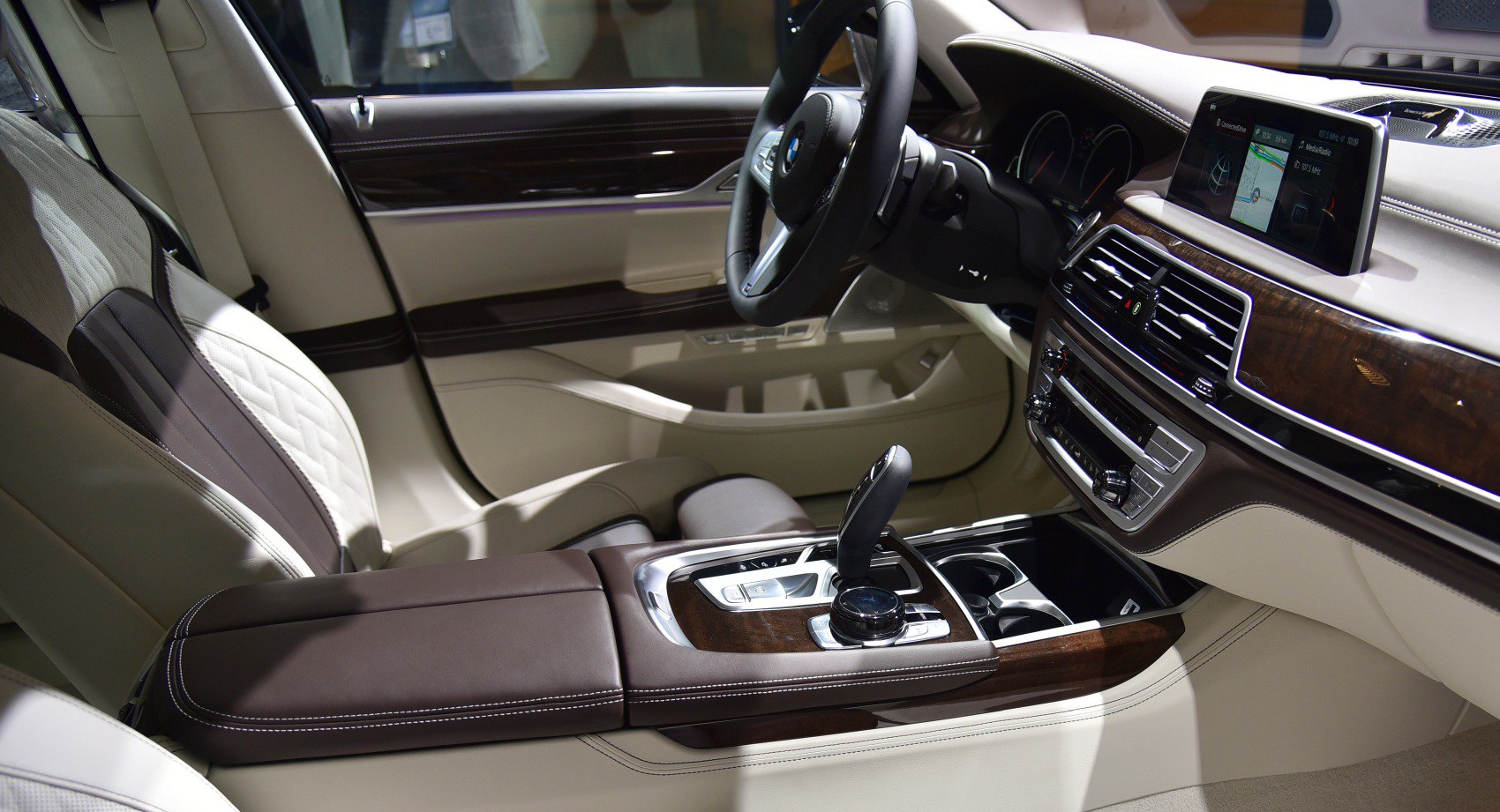 Luxurious interior with leather seats, wood trim, and advanced infotainment system