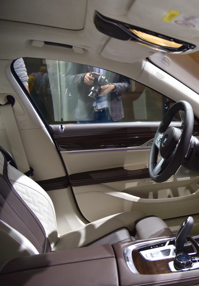 Luxury beige leather interior with wood trim and advanced gearshift controls