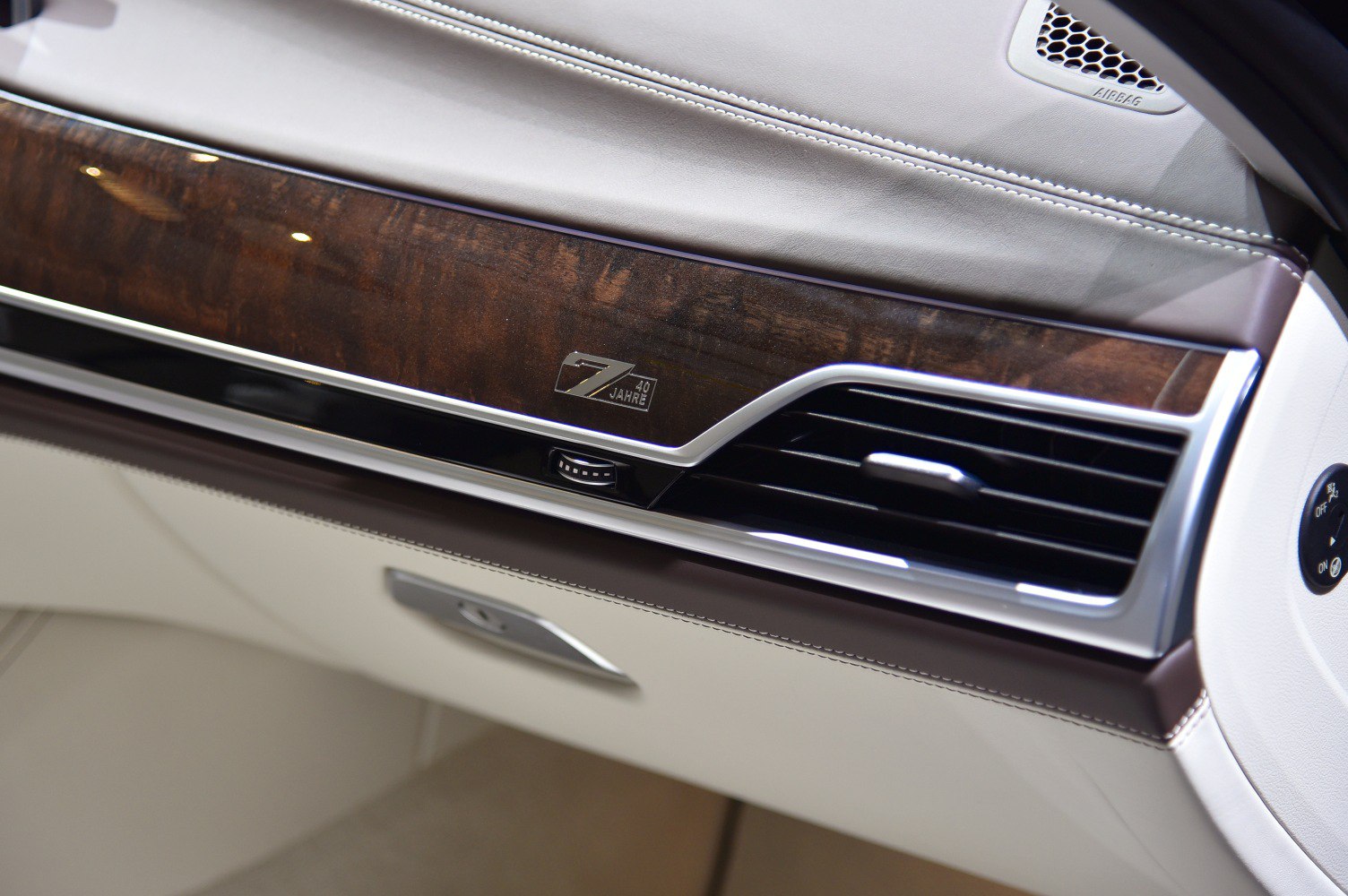 Luxury wood dashboard trim and air vent with 40 Jahre badge