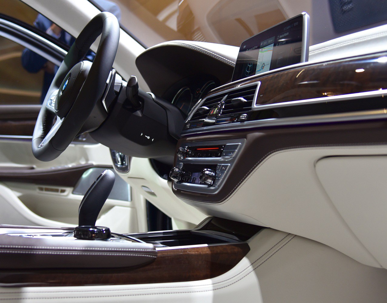 Luxury dashboard and steering wheel with wood trim and infotainment display