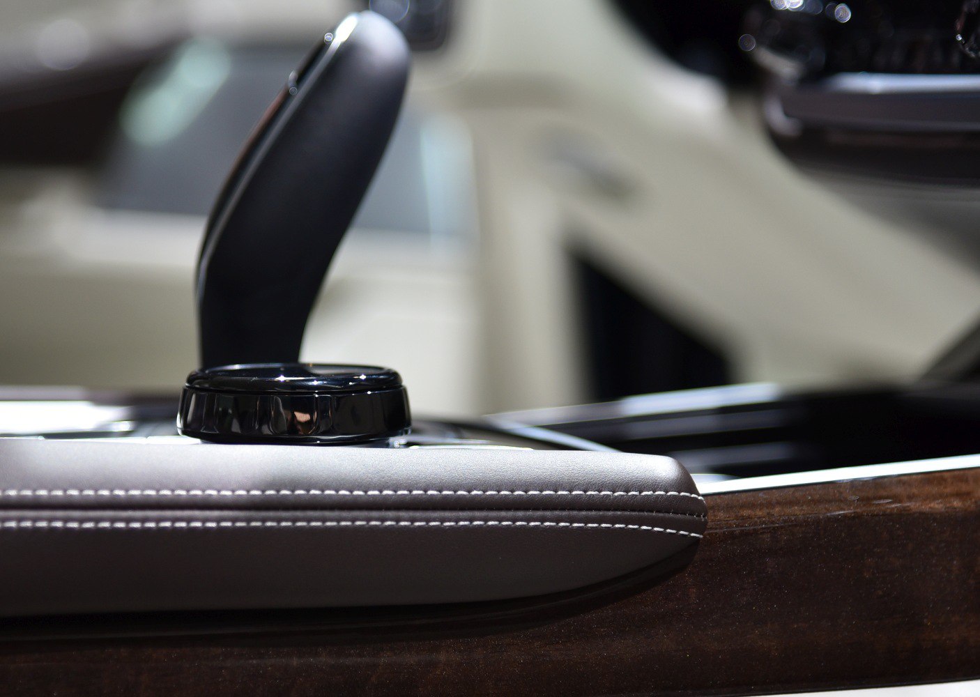 Close-up of interior control knob and leather stitching detail