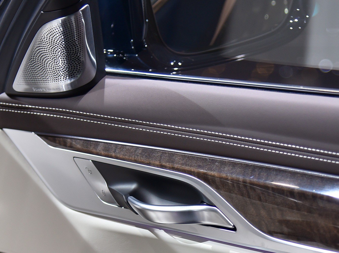 Car door handle with wood trim and Bowers & Wilkins speaker detail