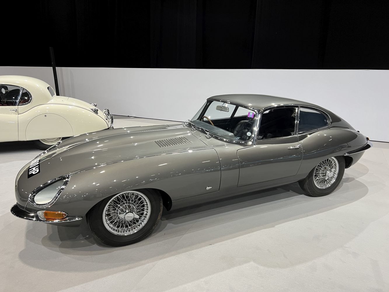 Sleek classic coupe with wire wheels and aerodynamic smooth body.