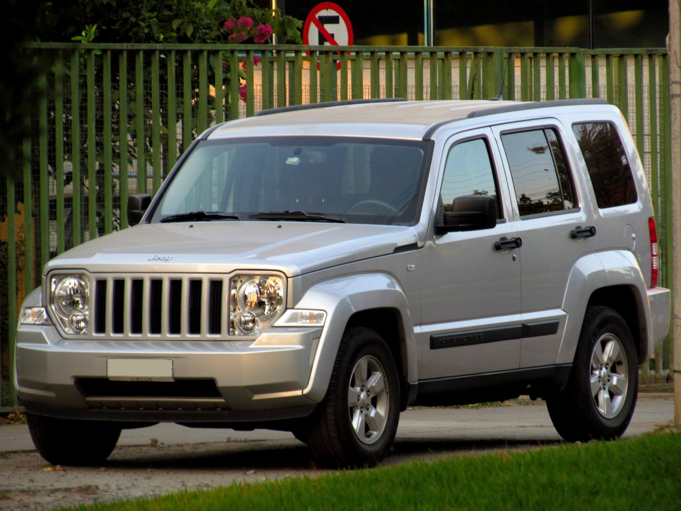 Silver SUV with front grille and four-door side view