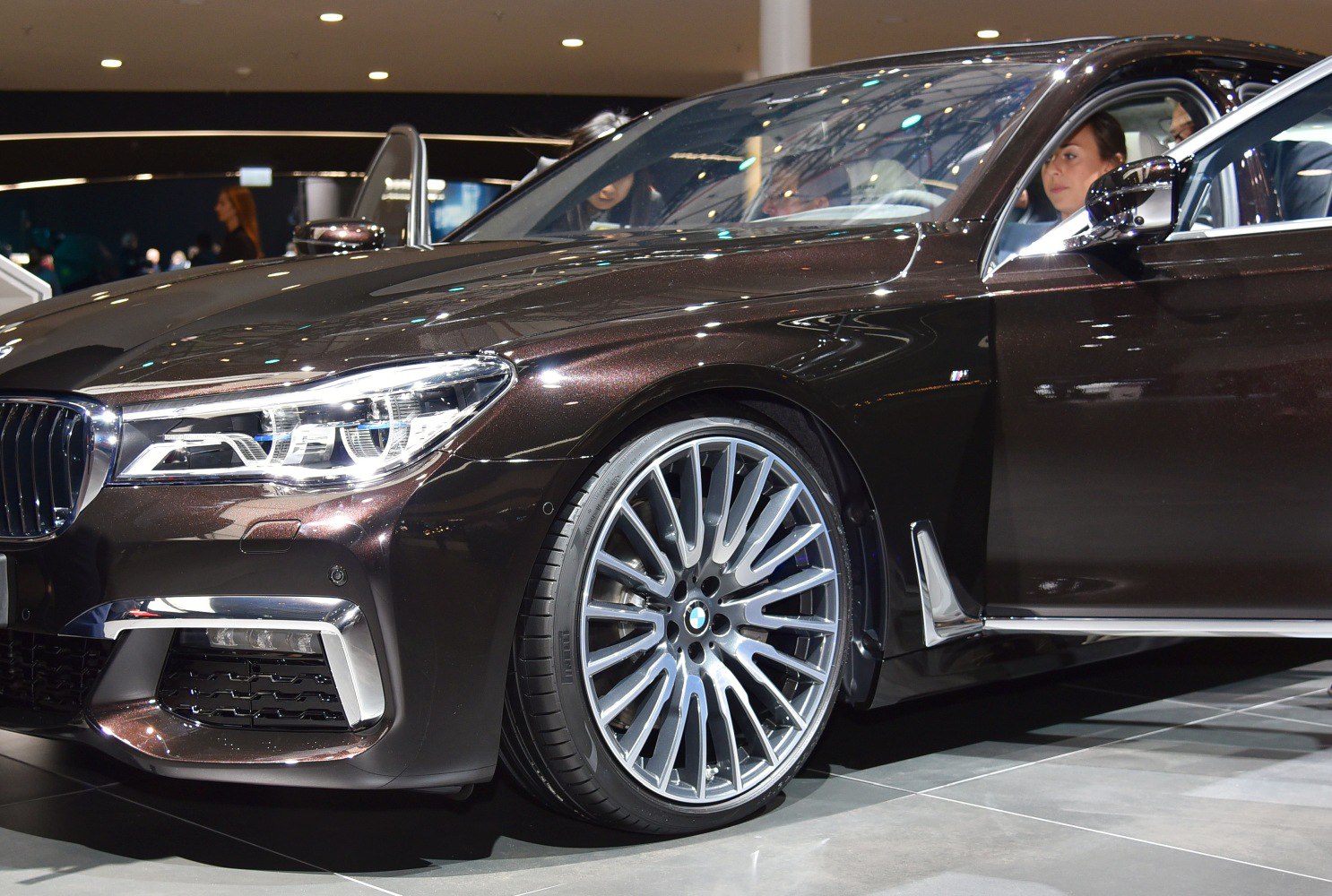 Modern LED headlights and large multi-spoke alloy wheels on luxury sedan