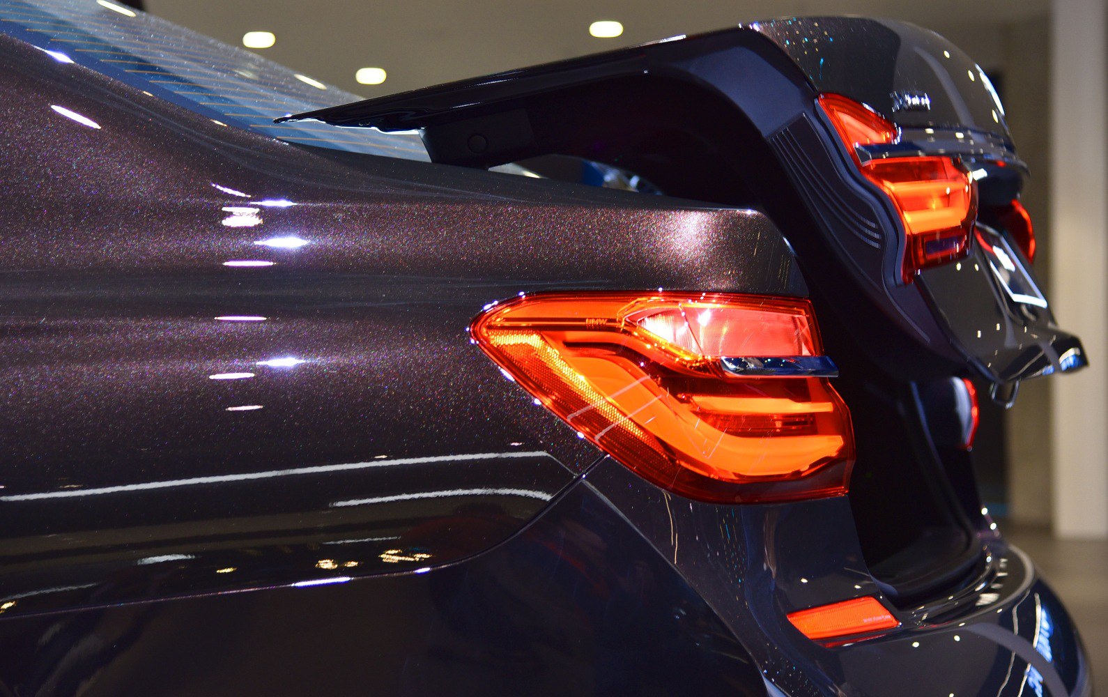 Close-up of rear tail light and open trunk