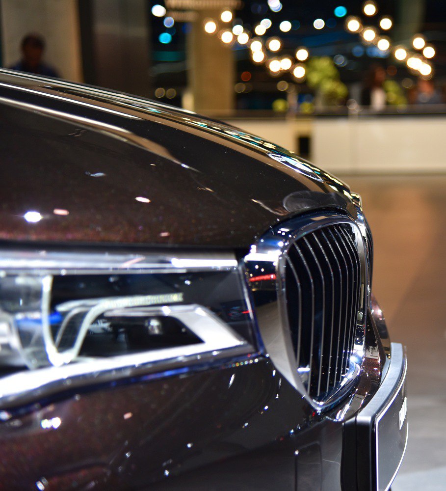 Close-up of car's front grille and headlight.