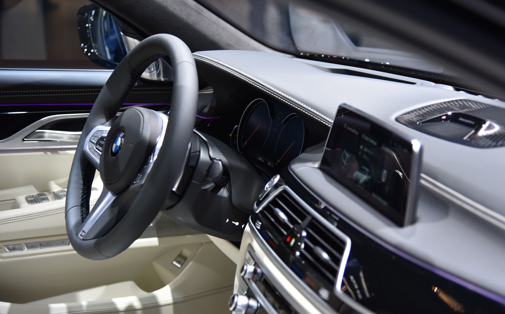 Luxury car interior with dashboard, steering wheel, and digital displays
