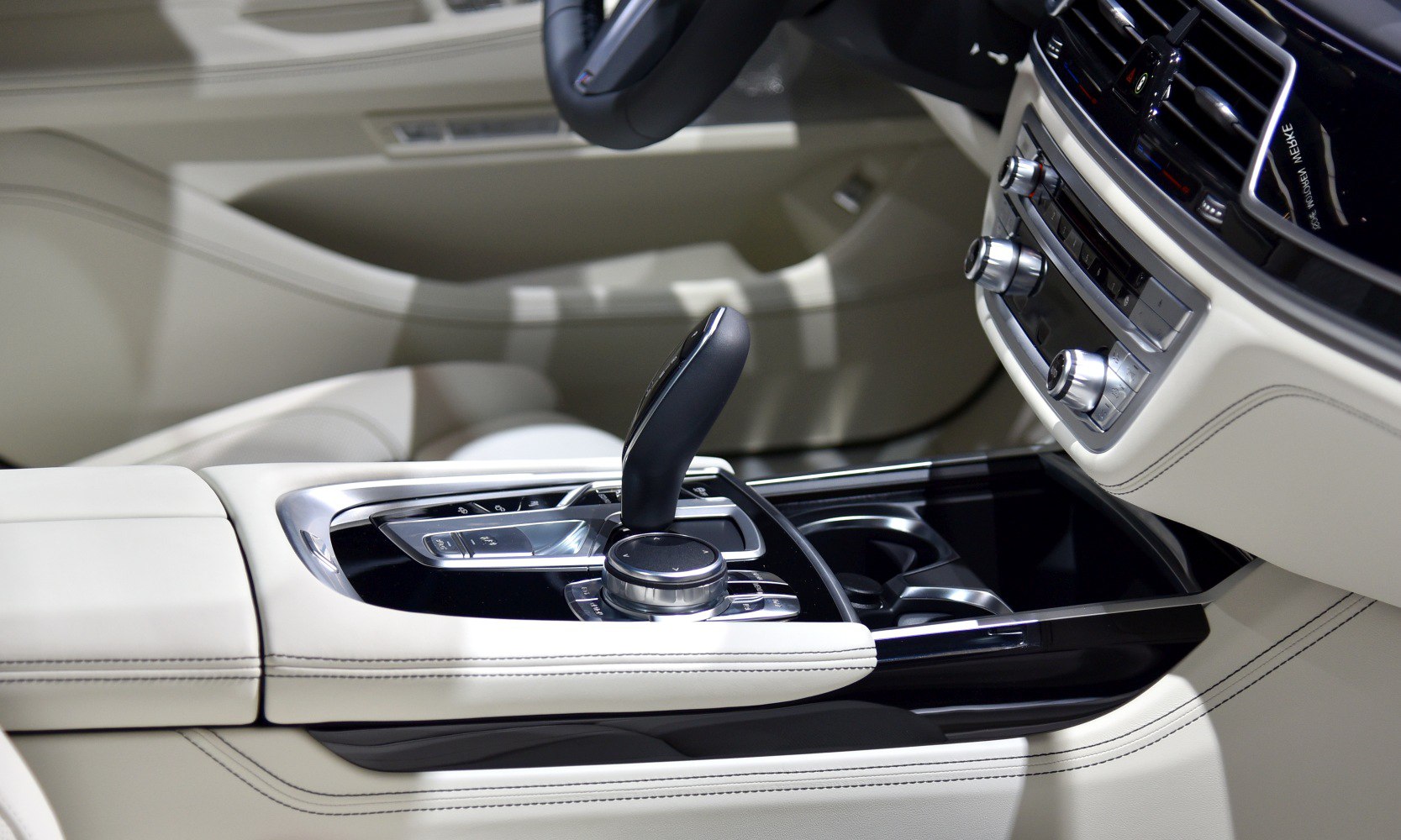 Close-up of gear shift lever and control knob in luxury car interior