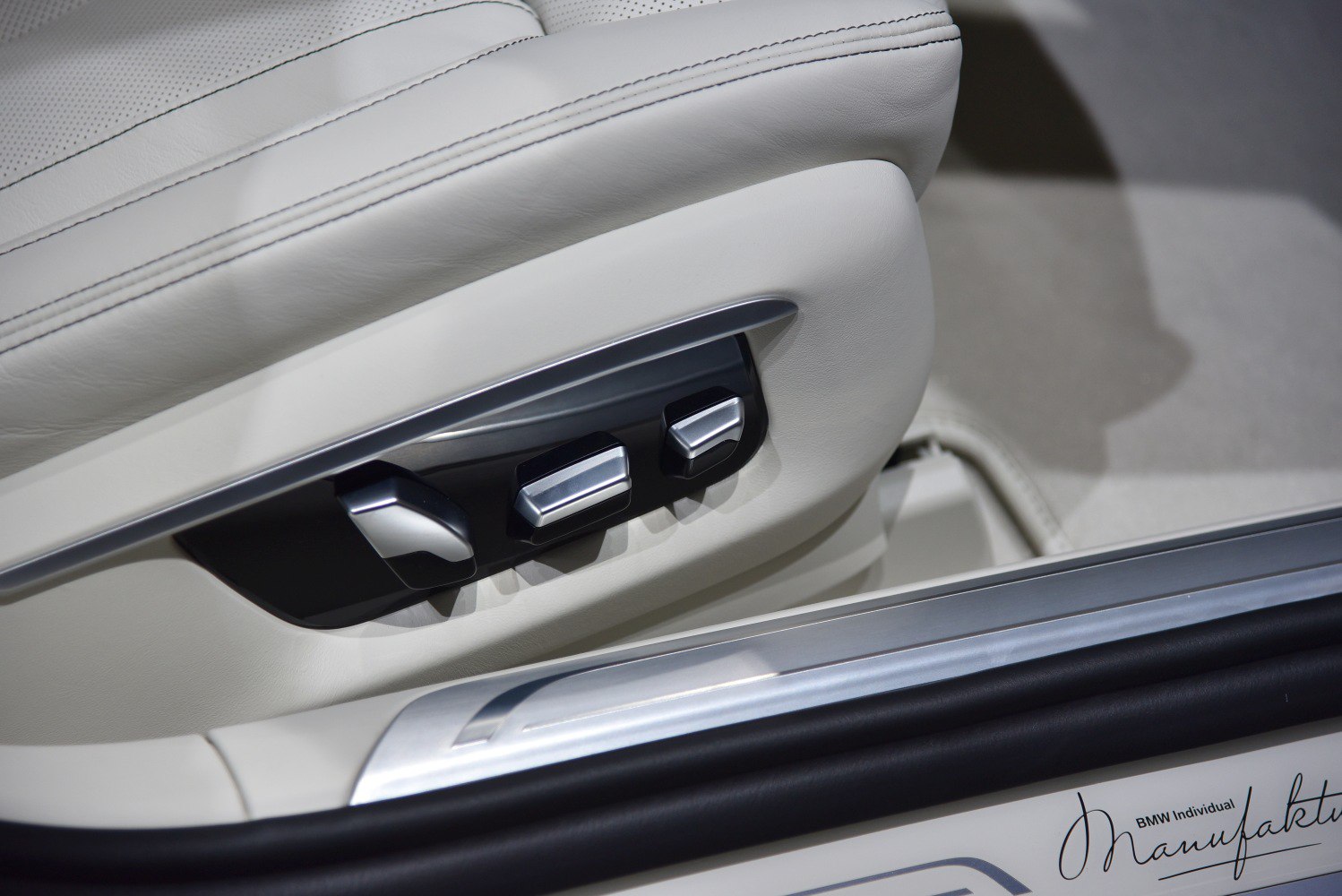 Electric seat adjustment controls on premium leather seat upholstery