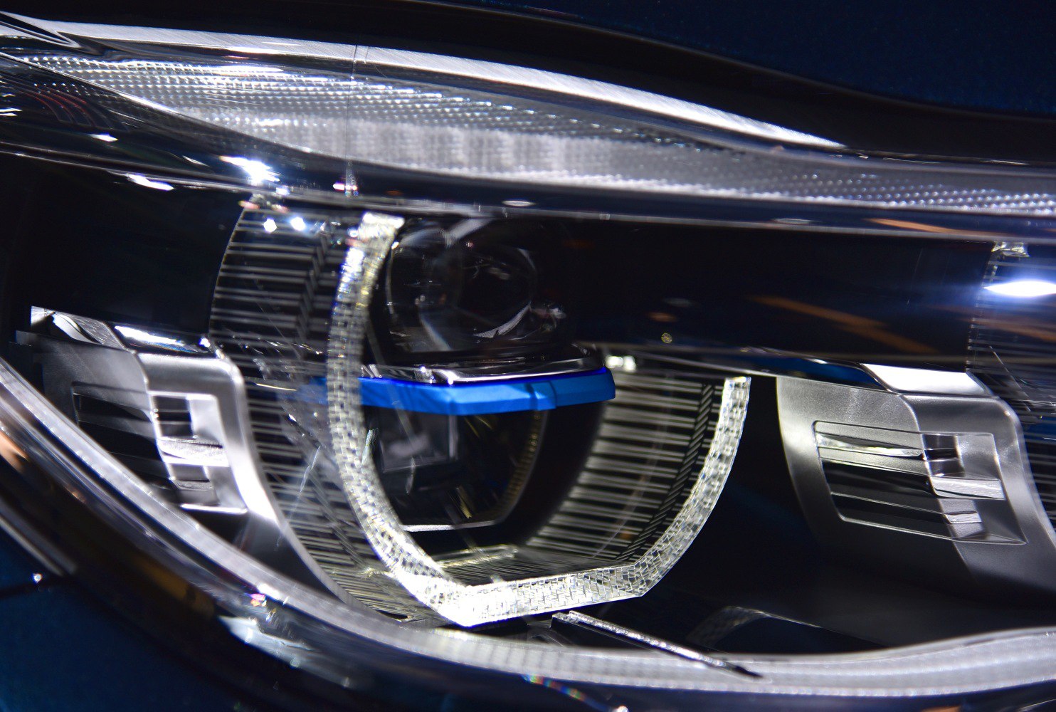 Close-up of a modern car projector headlight with LED accents