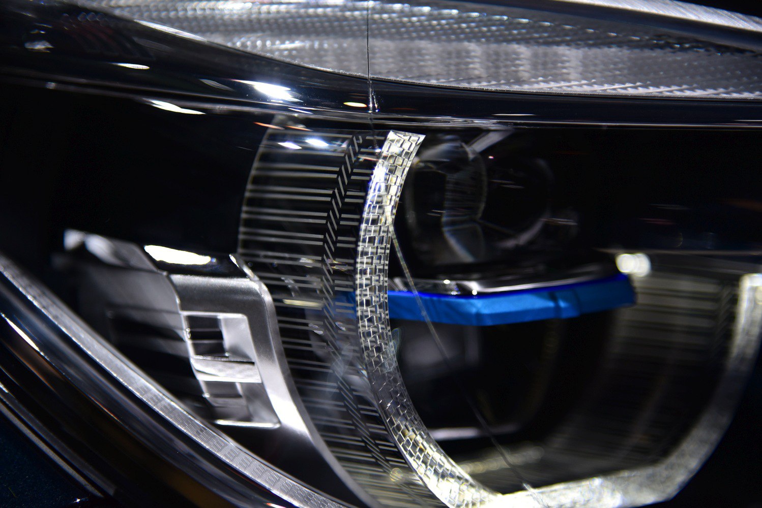 Close-up of LED headlight with detailed lens and light bar